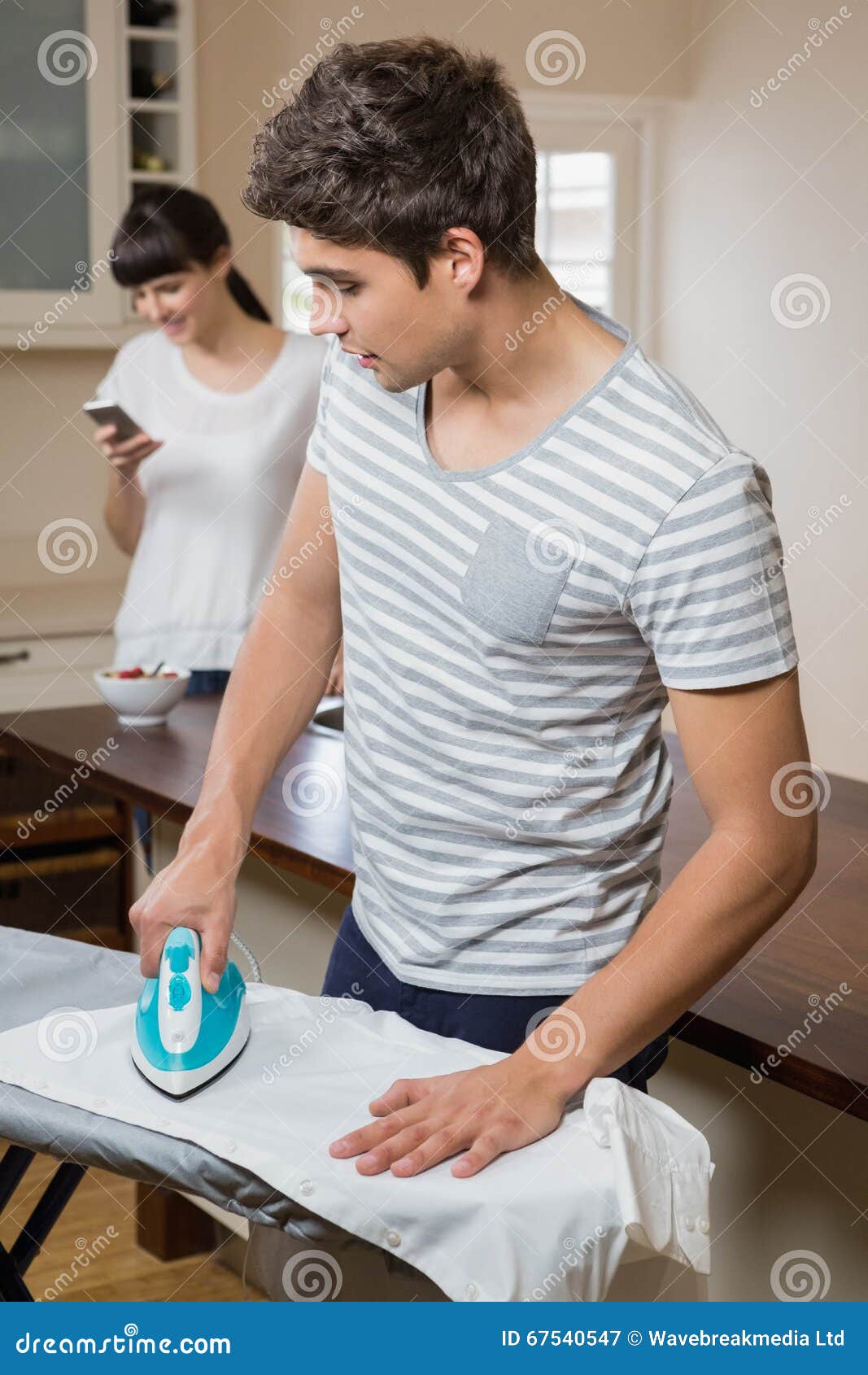 Man ironing a shirt stock image. Image of chores, female 67540547