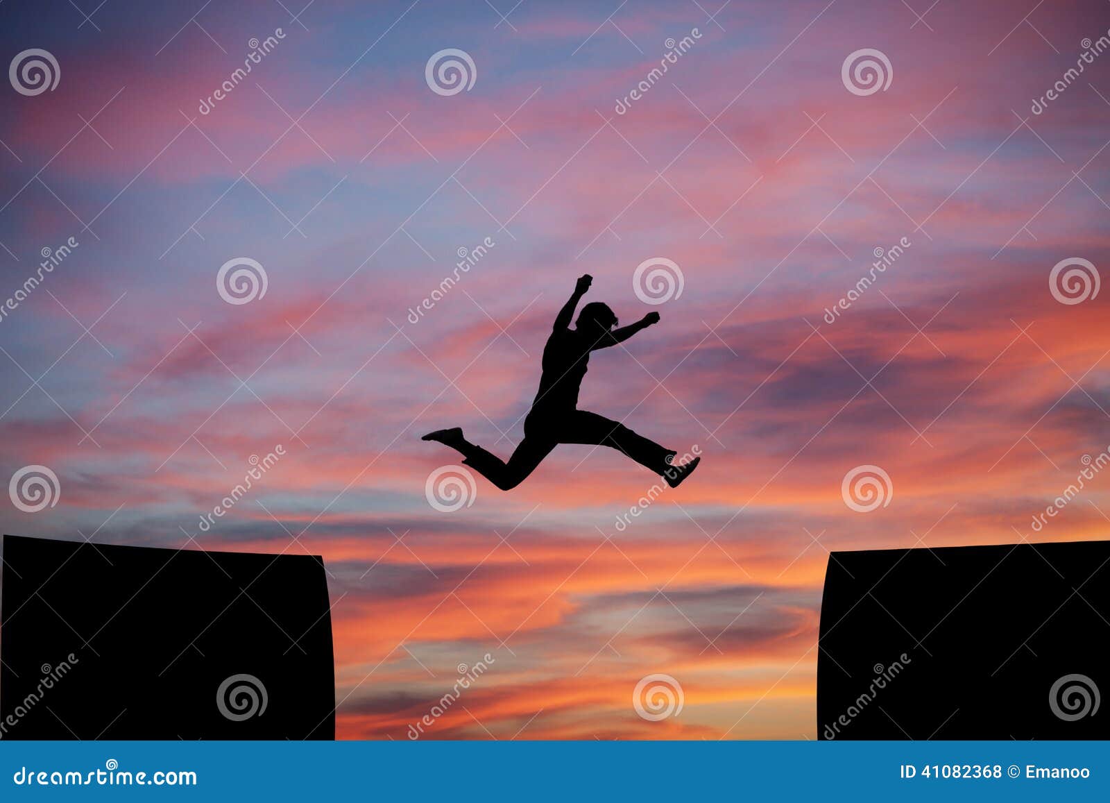 man jumping a gap in sunset sky