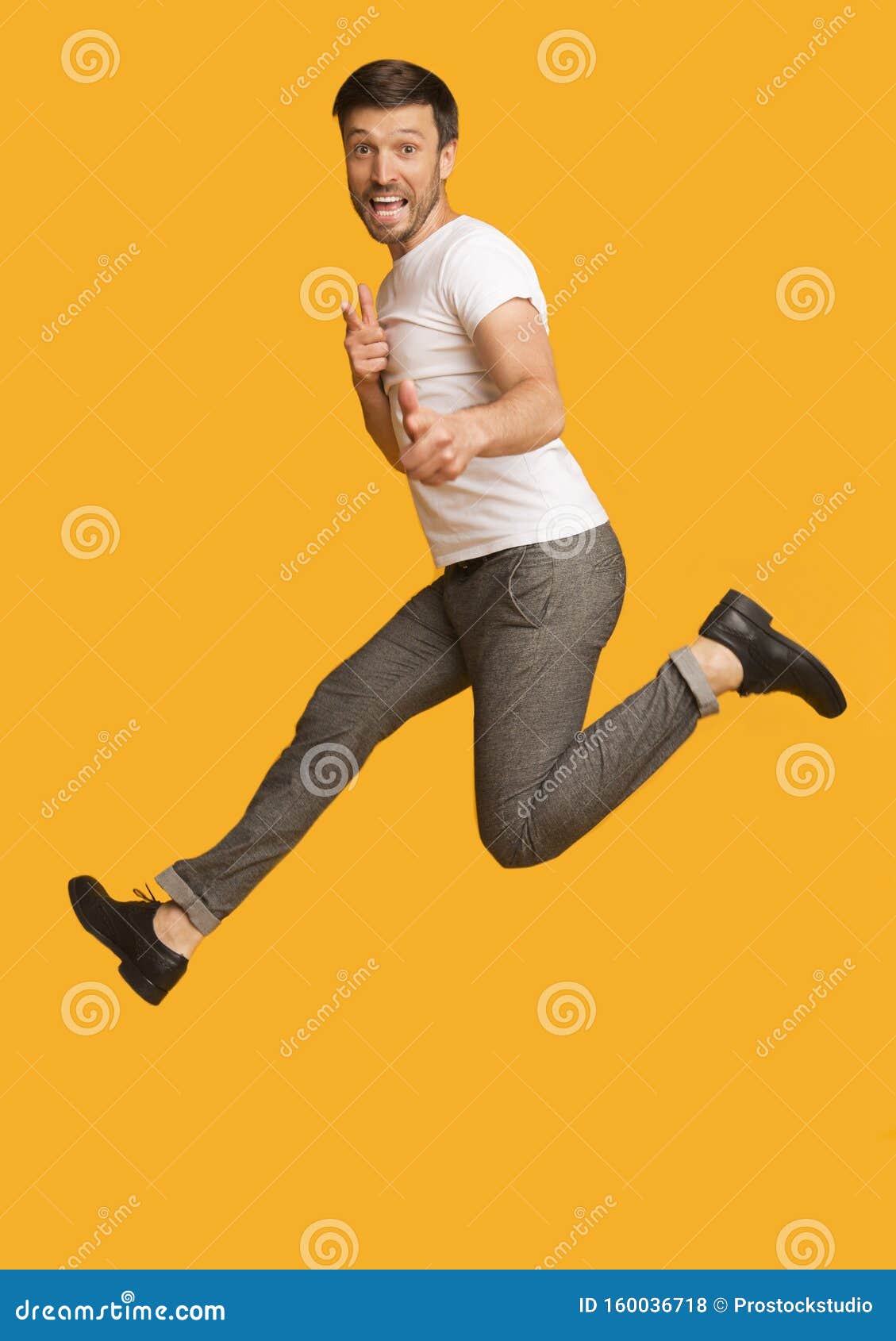 Man Jumping Pointing Fingers at Camera, Yellow Background Stock Photo -  Image of camera, male: 160036718