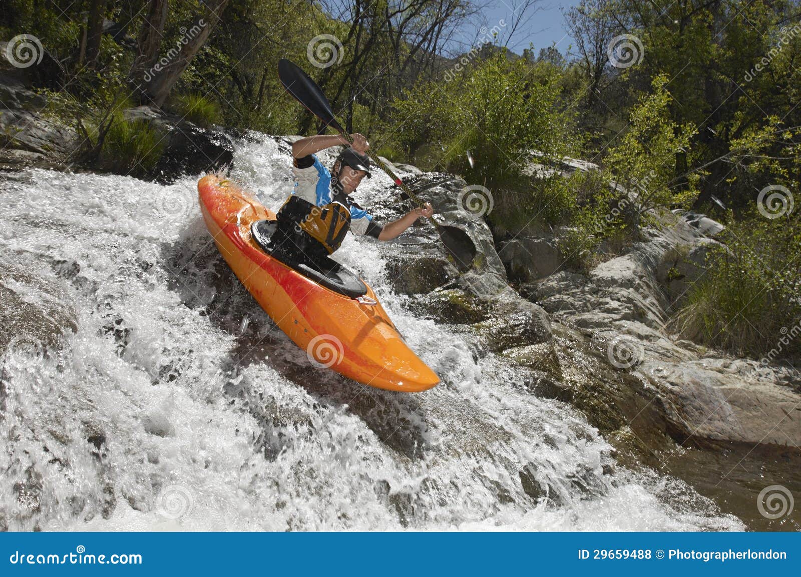 man kayaking on mountain river