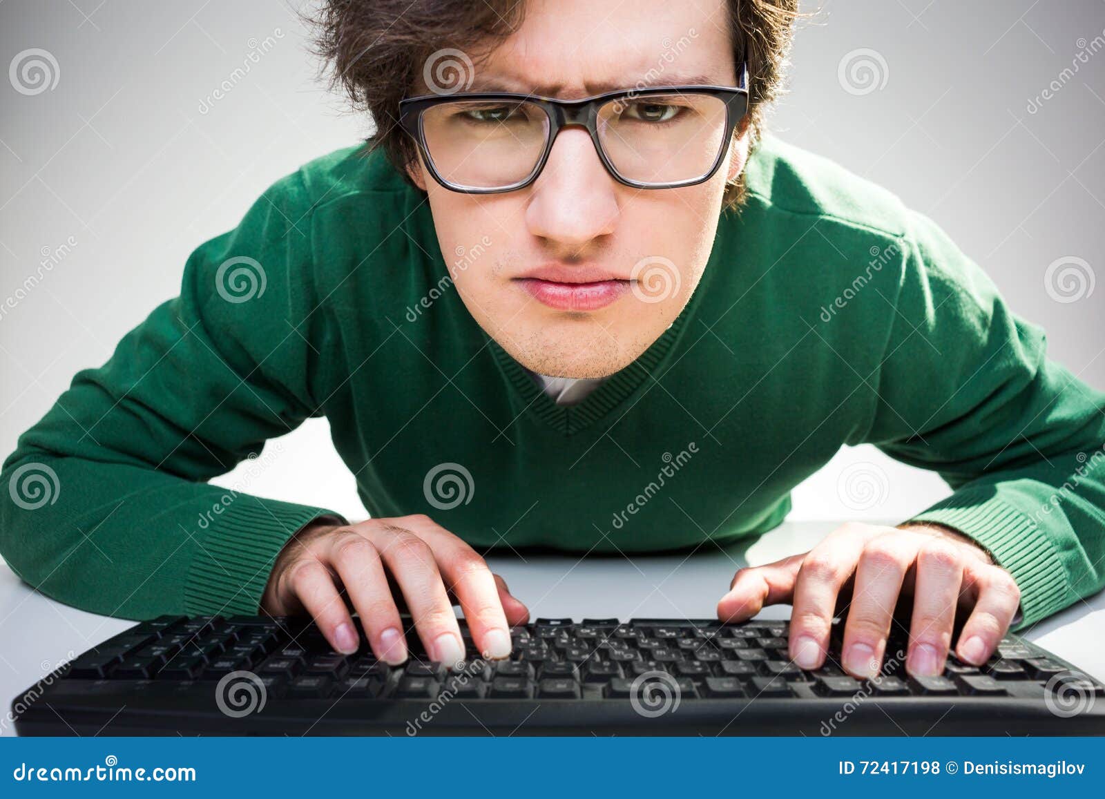 Man With Keyboard Looking Closely Stock Photo Image Of Desktop