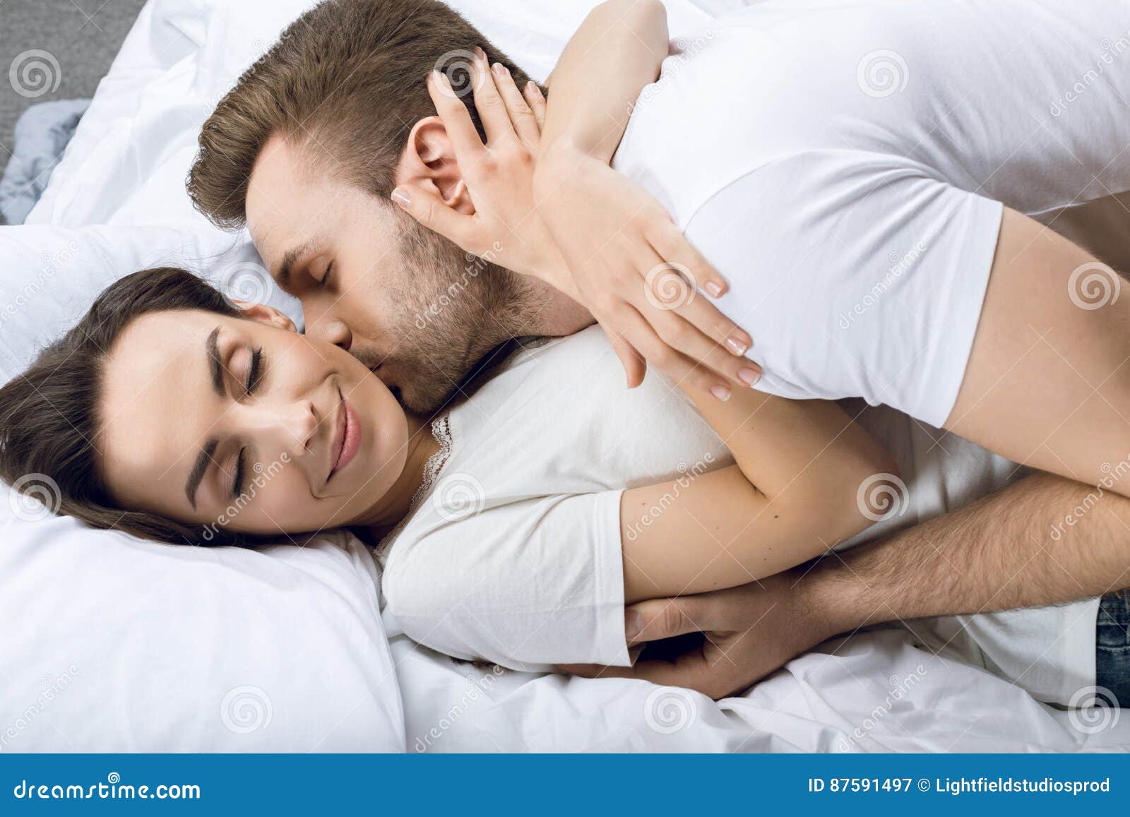 Man Kissing Smiling Woman In Bed Stock Image   Image of european 