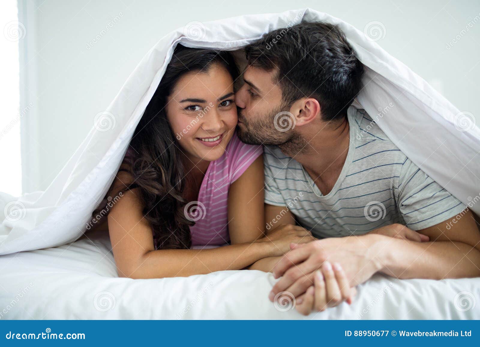 Man Kissing Woman Under Blanket In The Bedroom Stock Image Image Of