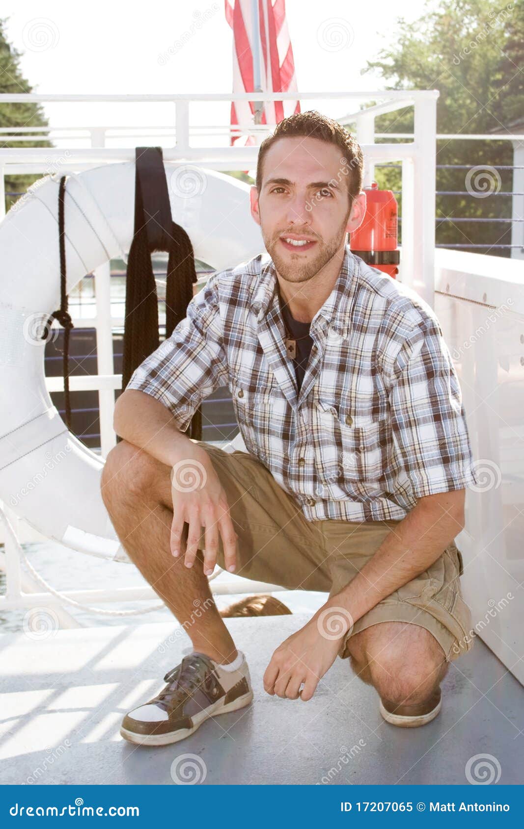 Man kneeling on a boat stock image. Image of young, casual - 17207065