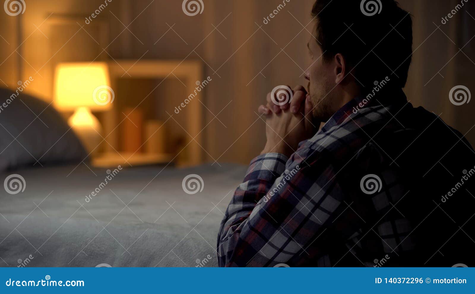 man kneeling near bed and praying to god, thanking for life opportunities