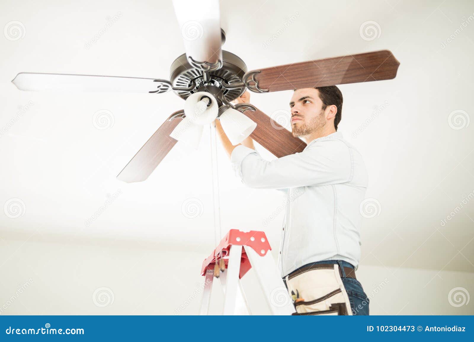 Man In Ladder Fixing Ceiling Fan Stock Image Image Of
