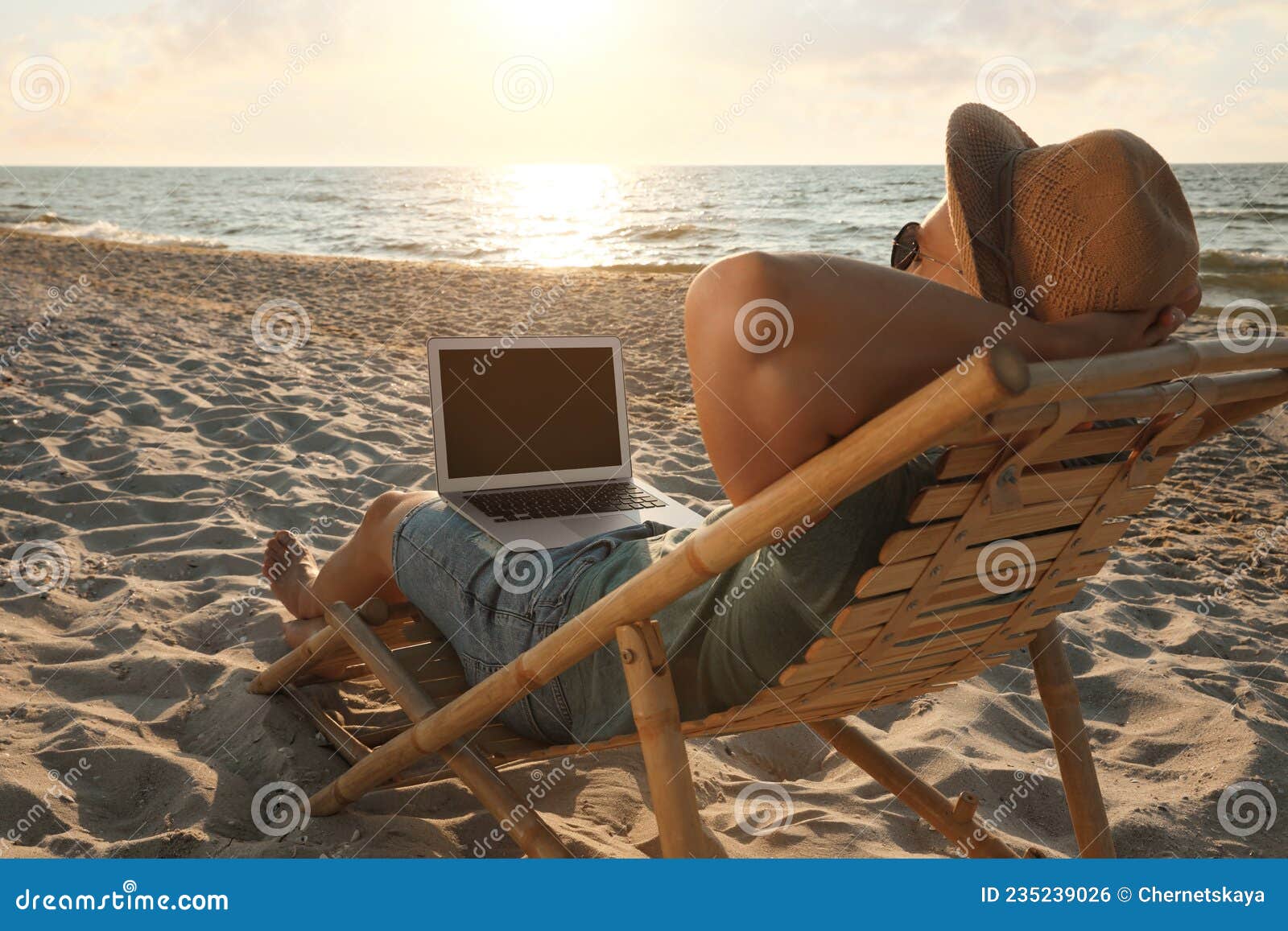 Man with Laptop Relaxing in Deck Chair on Beach Stock Photo - Image of ...