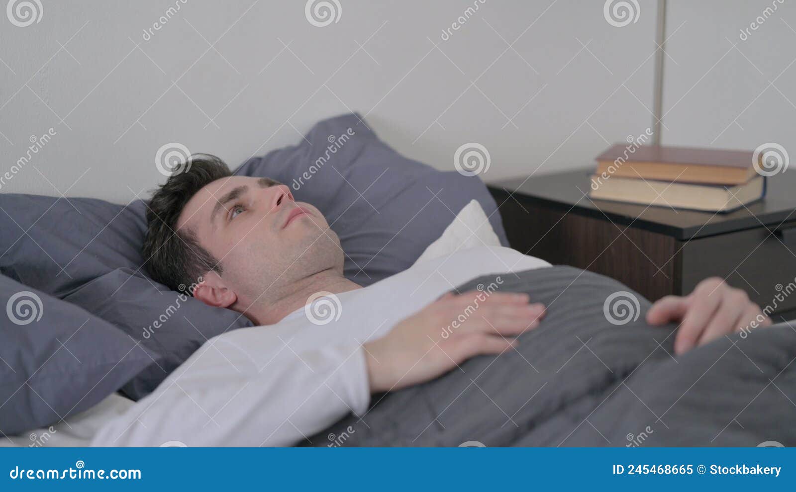 Man Laying in Bed Unable To Sleep Stock Image Image of home, tired