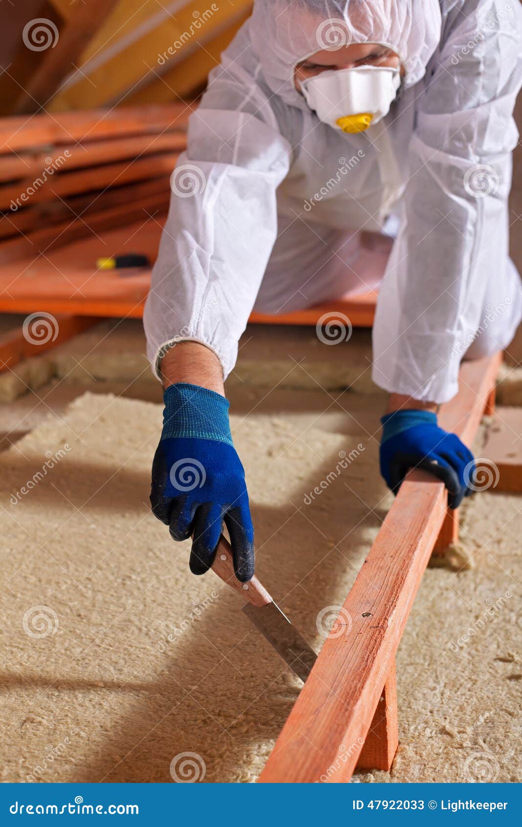 man laying thermal insulation layer on building