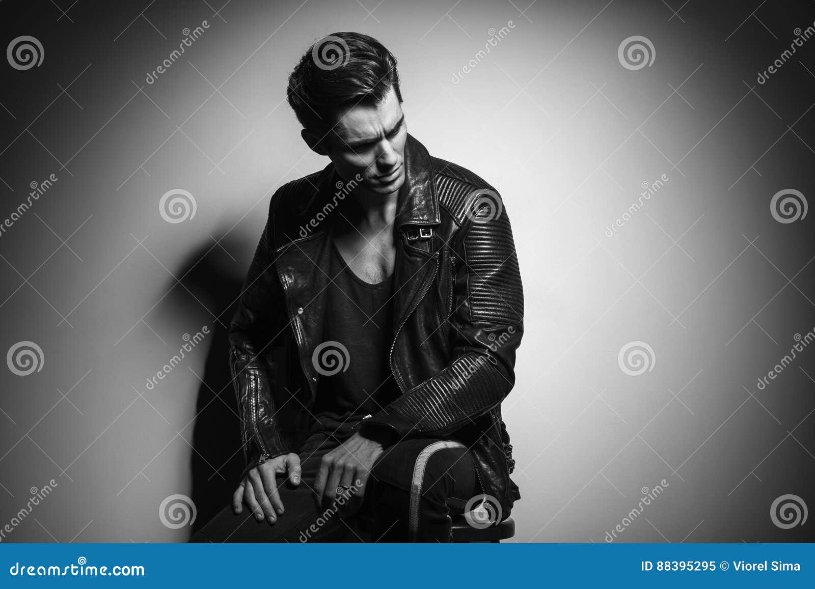 Man in Leather Jacket Looks To Side while Sitting Stock Image - Image ...