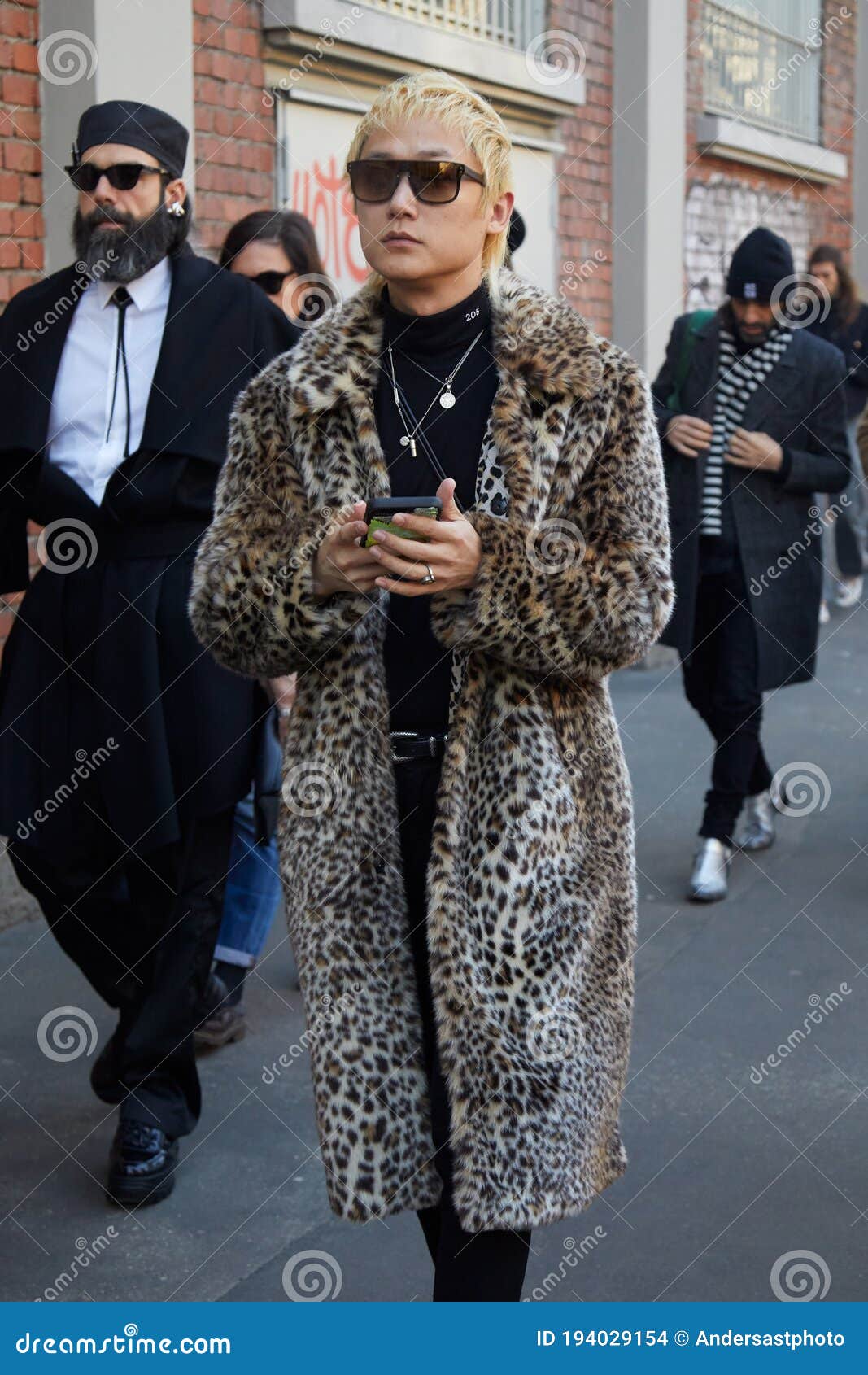 MILAN - JANUARY 15: Man with blue fur coat and Faure Le Page bag looking at  smartphone before Giorgio Armani fashion show, Milan Fashion Week street s  Stock Photo - Alamy