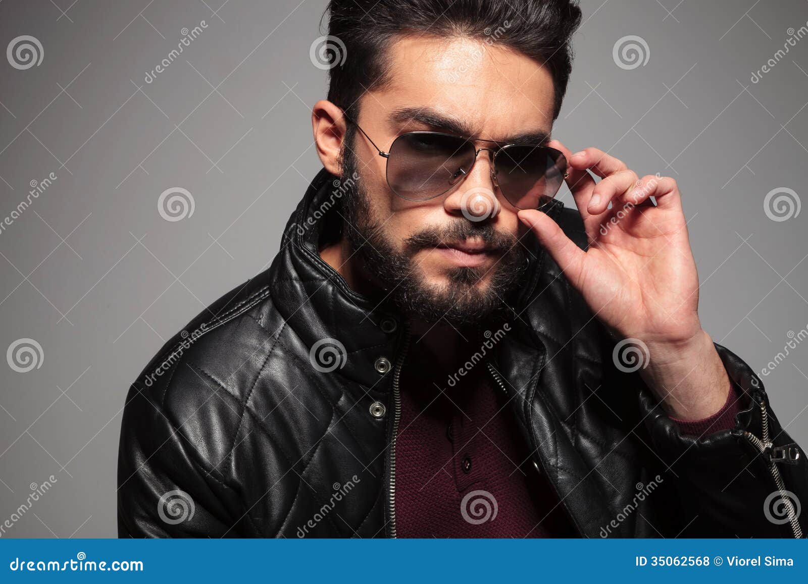 Man With Long Beard Fixing Or Putting On His Sunglasses 
