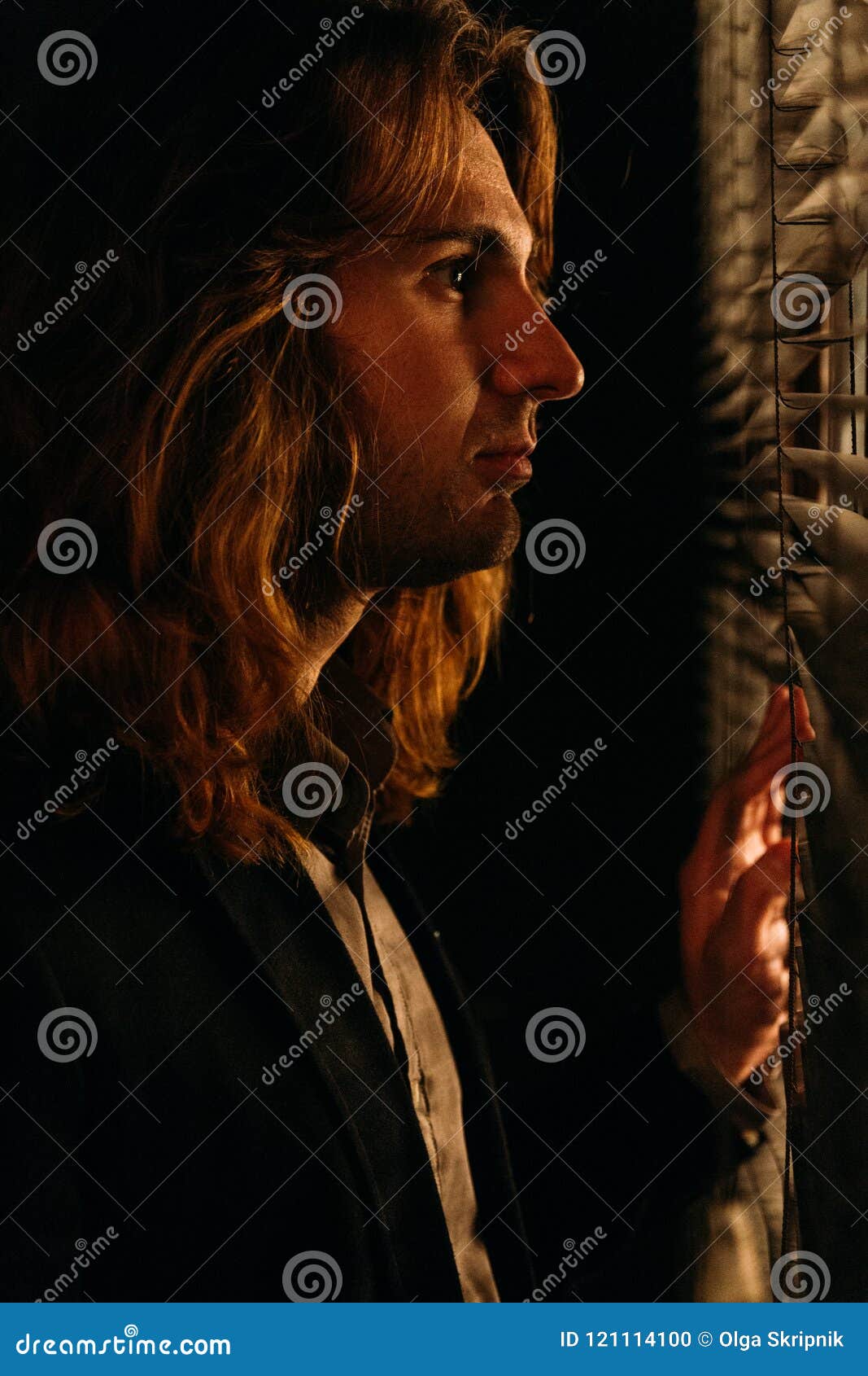 A Man with Long Hair is Standing Near the Window, Opening the Blinds with  Lobes, in a Black Jacket. Look at the Street, Spy on Peo Stock Photo -  Image of lifestyle,
