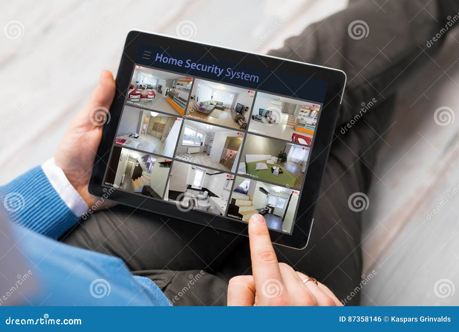 man looking at home security cameras on tablet computer