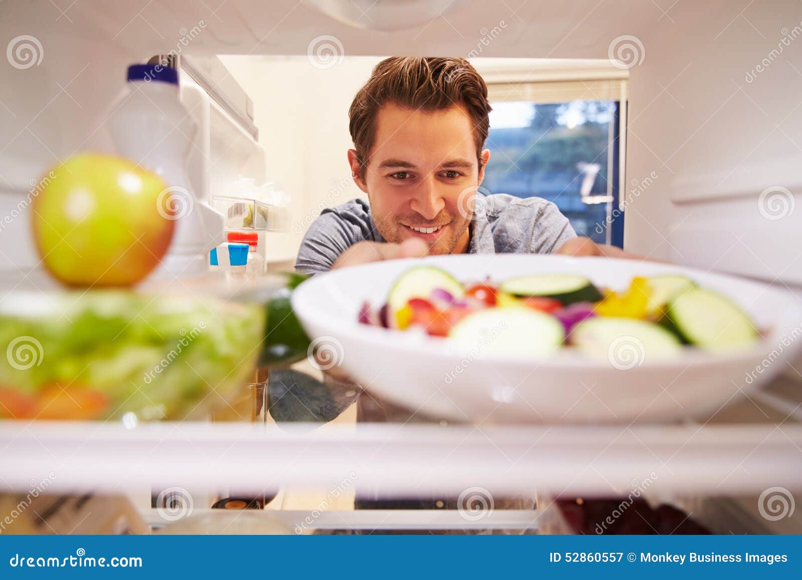 Man Looking For Food In Fridge RoyaltyFree Stock Photography
