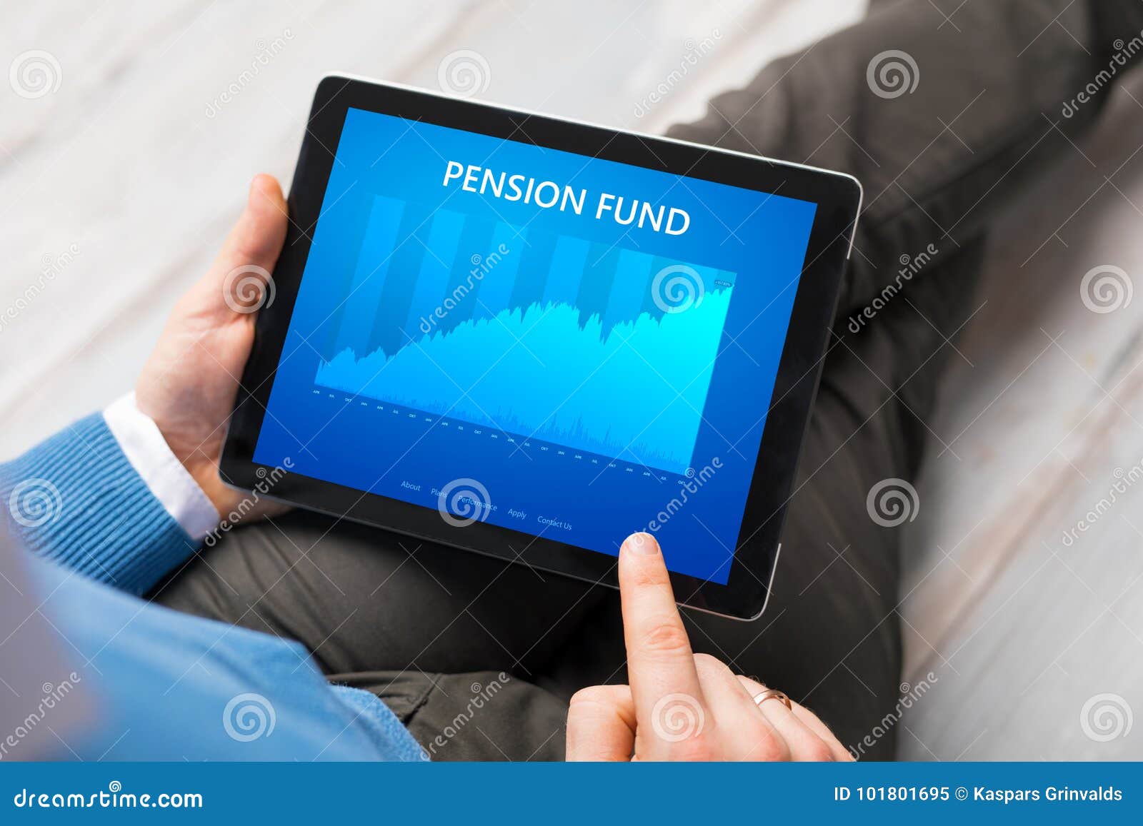man looking at pension fund performance graph on tablet computer.