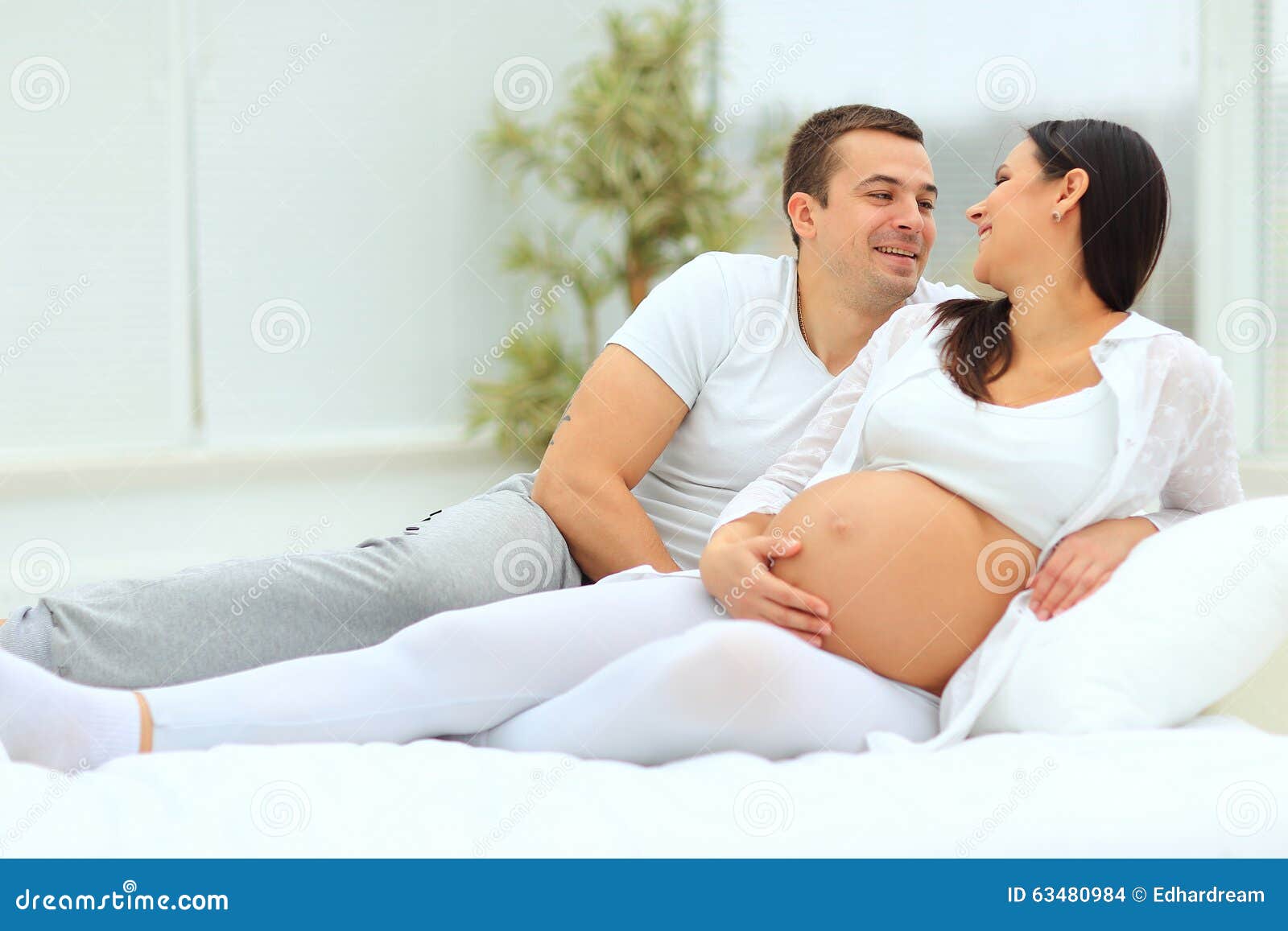 Man Looks Lovingly At His Pregnant Stock Photo - Image of ...