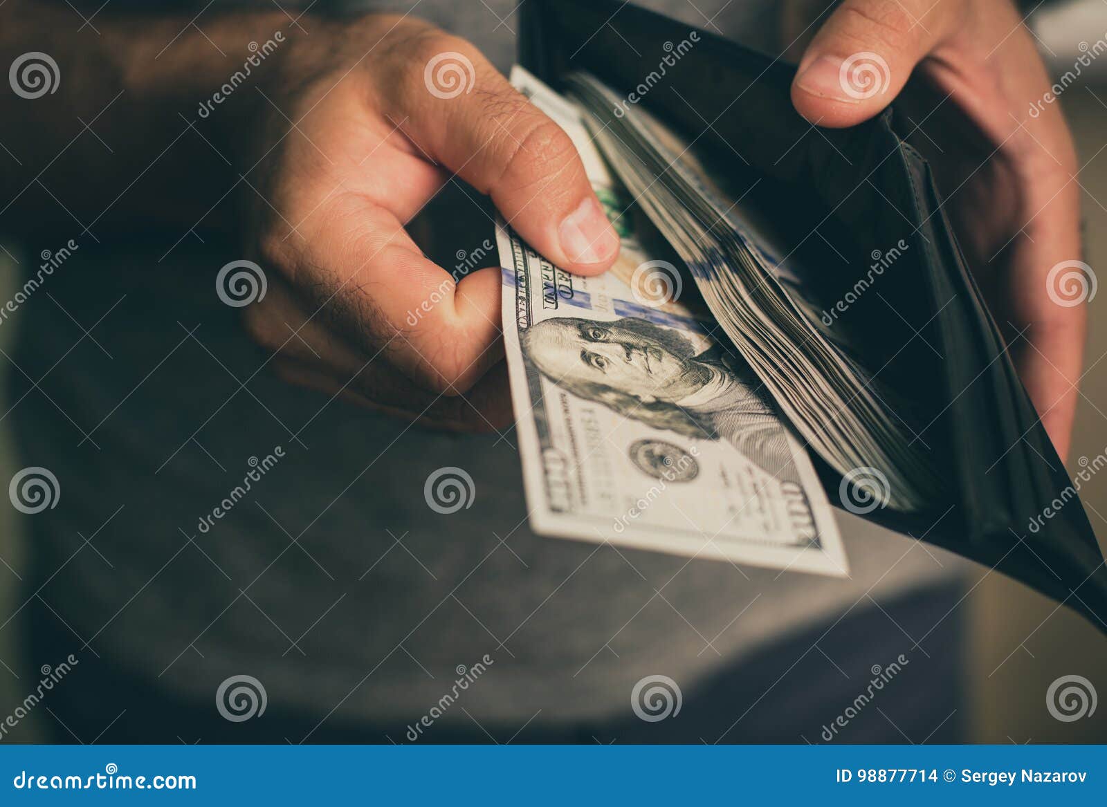 man looks in the wallet. cash. wealthy man counting his money. close up.