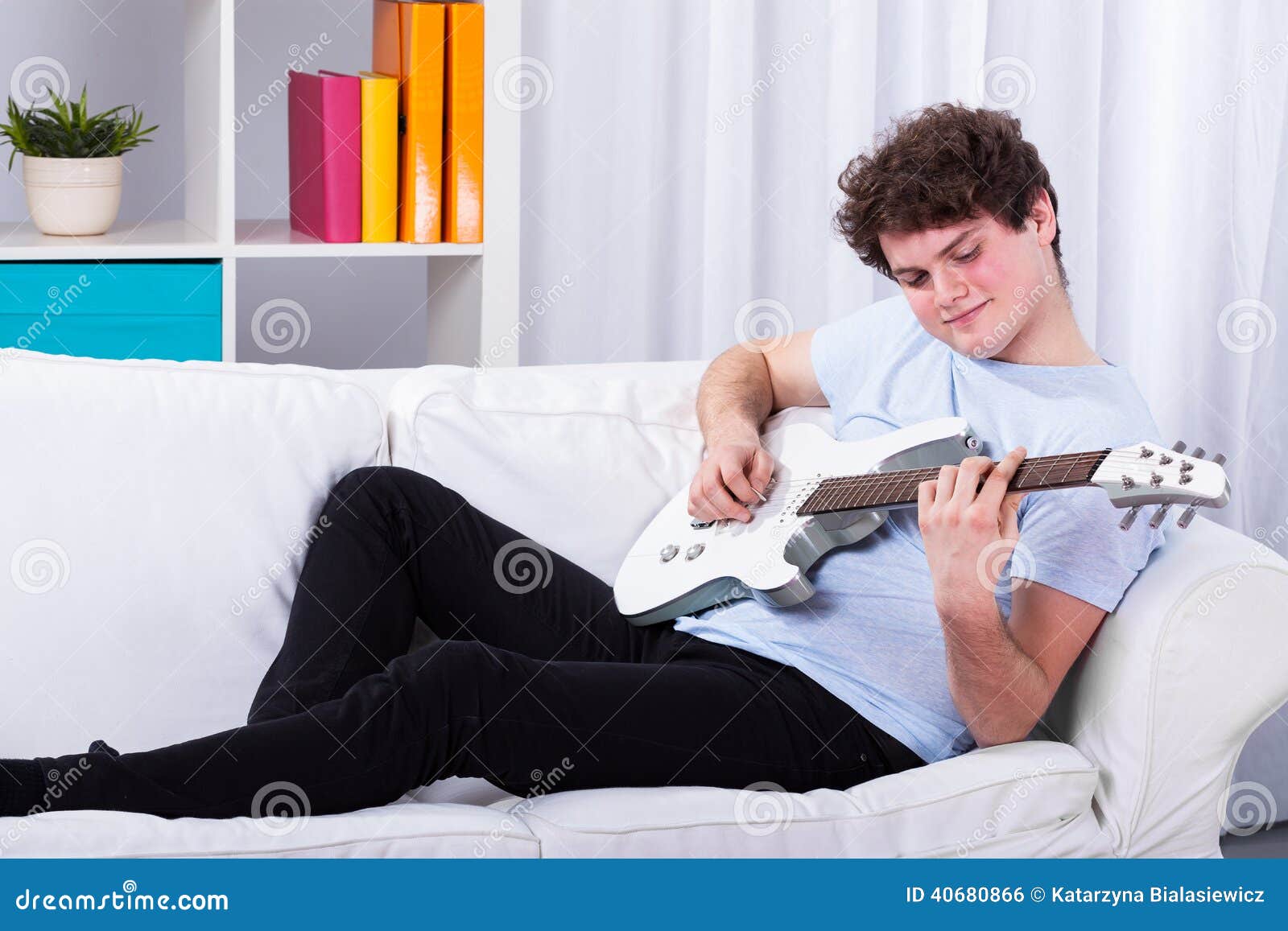 Man Lying On A Couch And Playing Guitar Stock Photo Image Of Relax