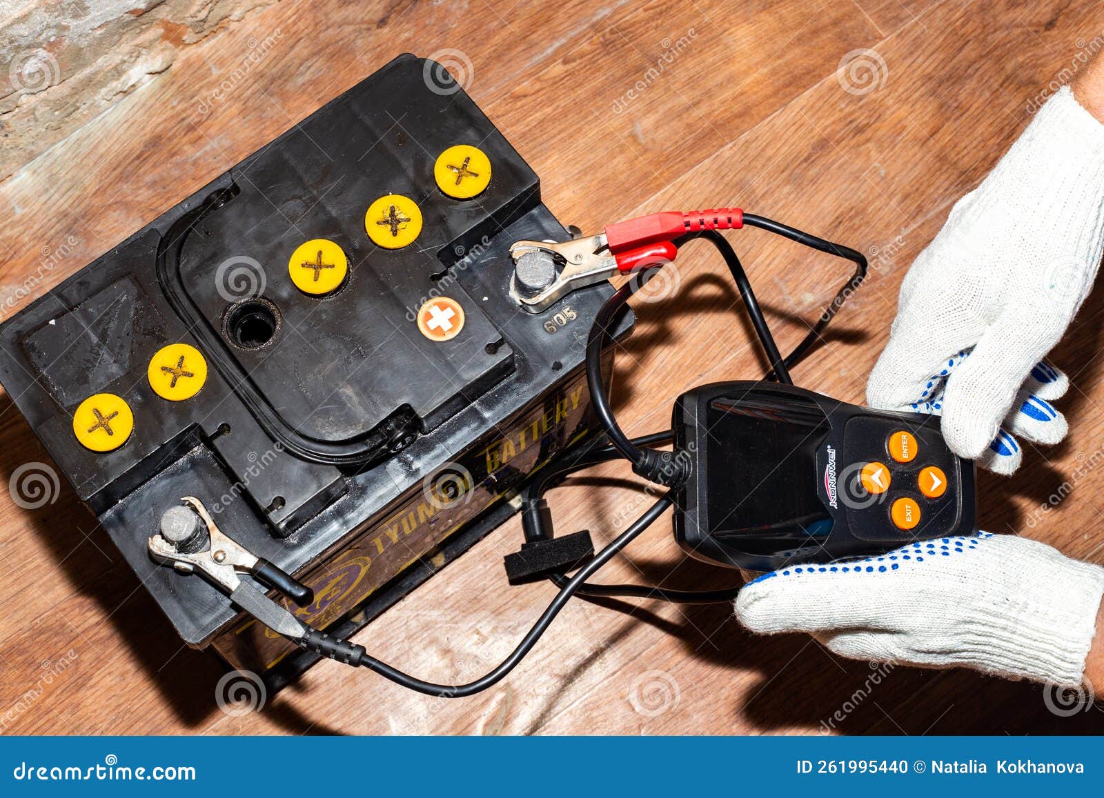 A Man Measures the Capacity and Current of a Car Battery with a