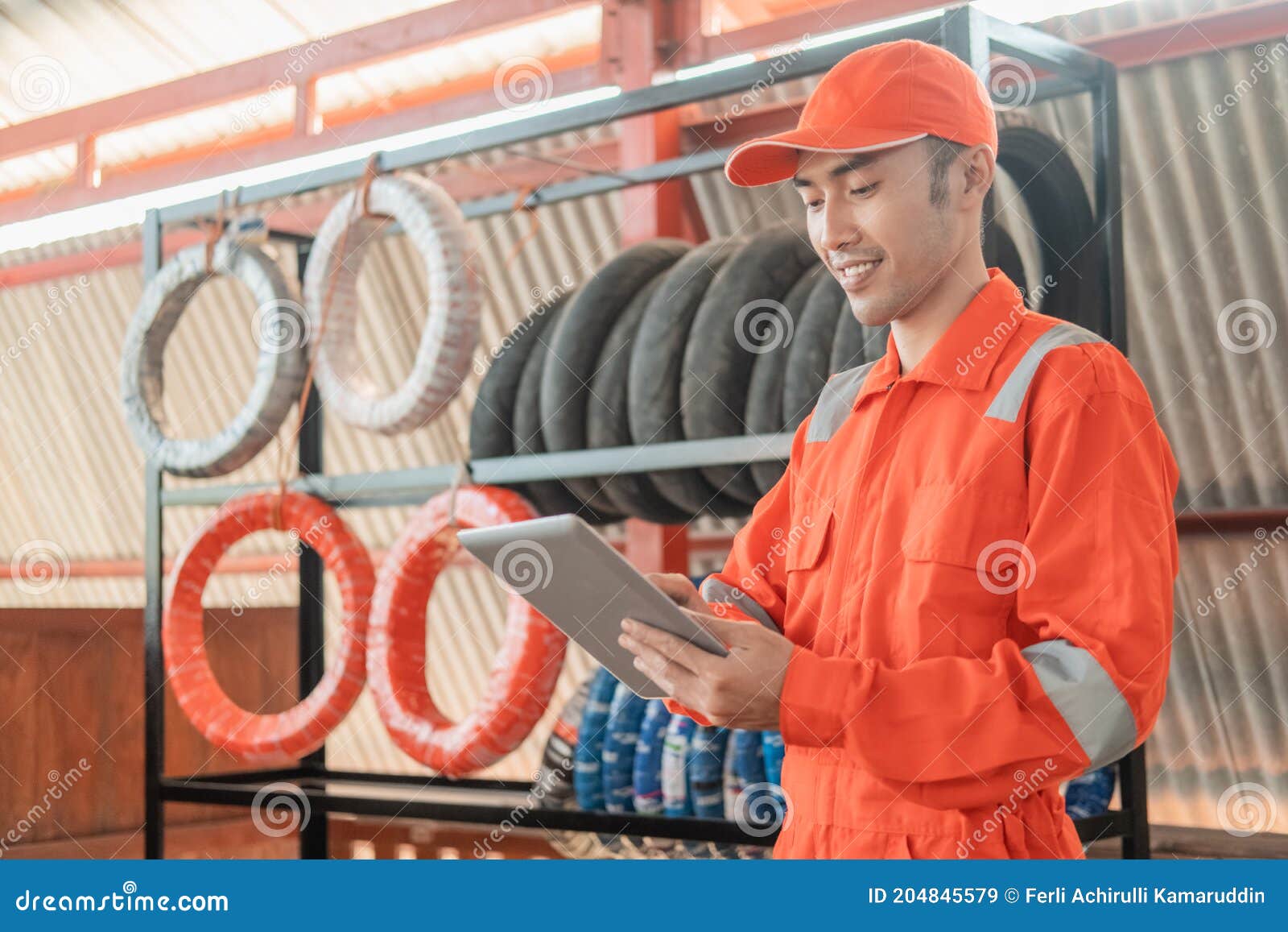 a man mechanic in wearpack using a digital tablet