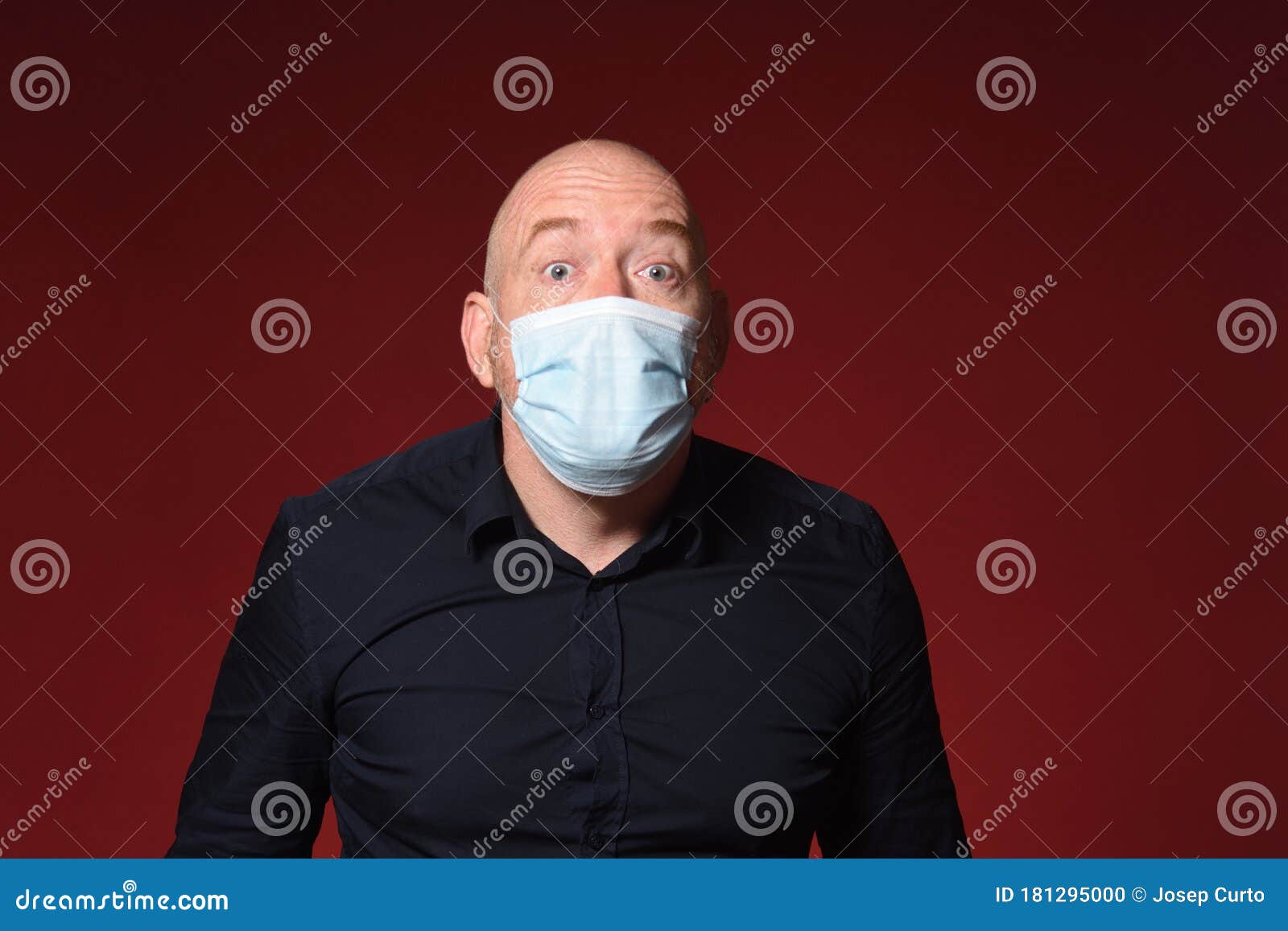 man with medical mask expresion surprise on red background