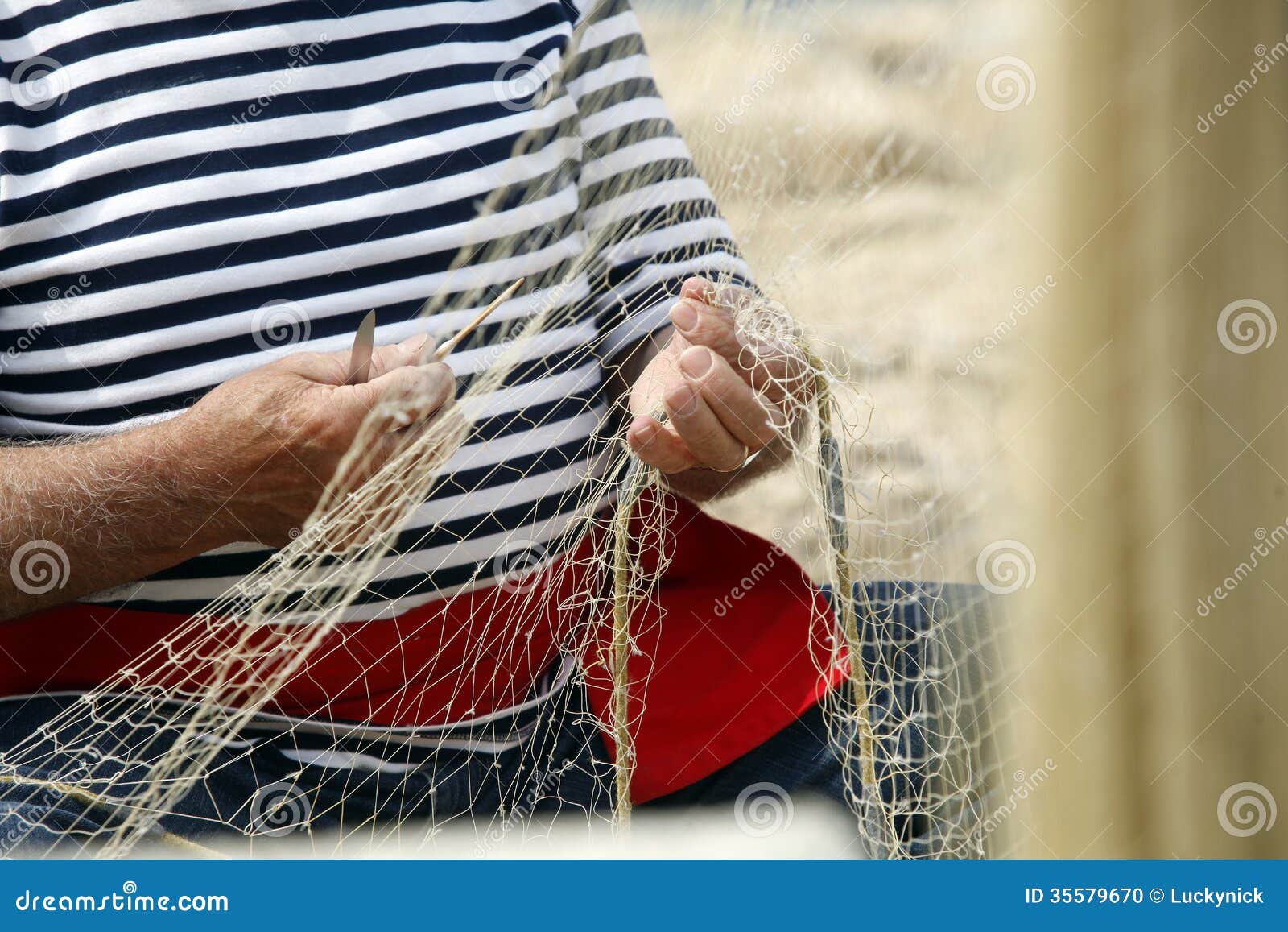 man mending nets