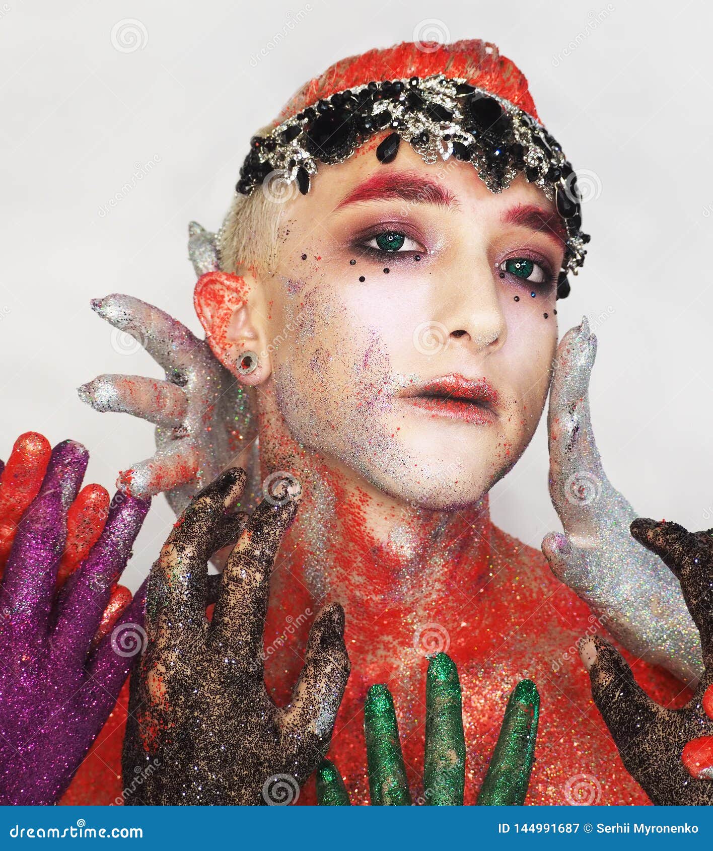 Man Model at the Art Make Up with Green Eyes Looking Forward from the