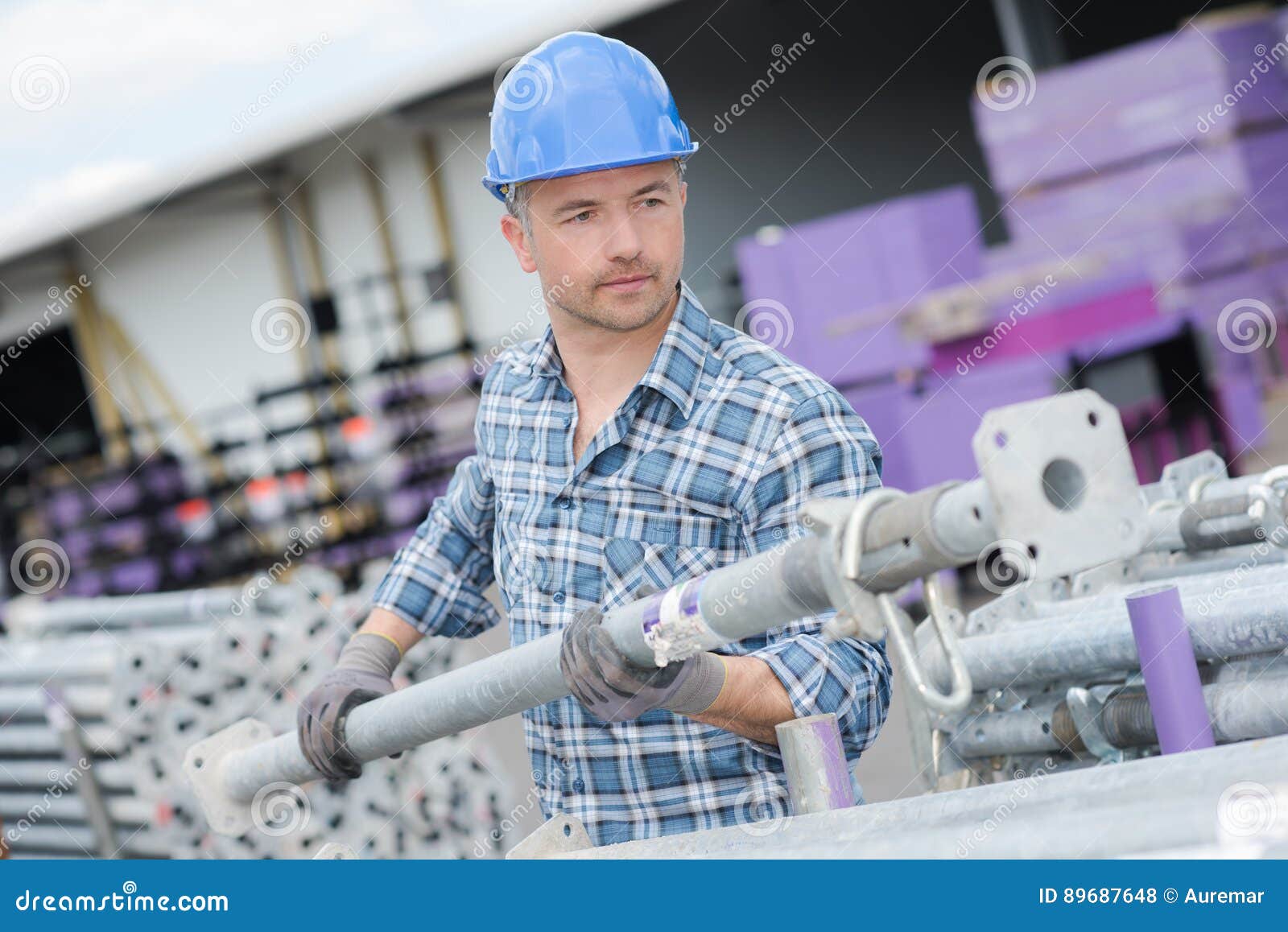 man moving scaffold pole
