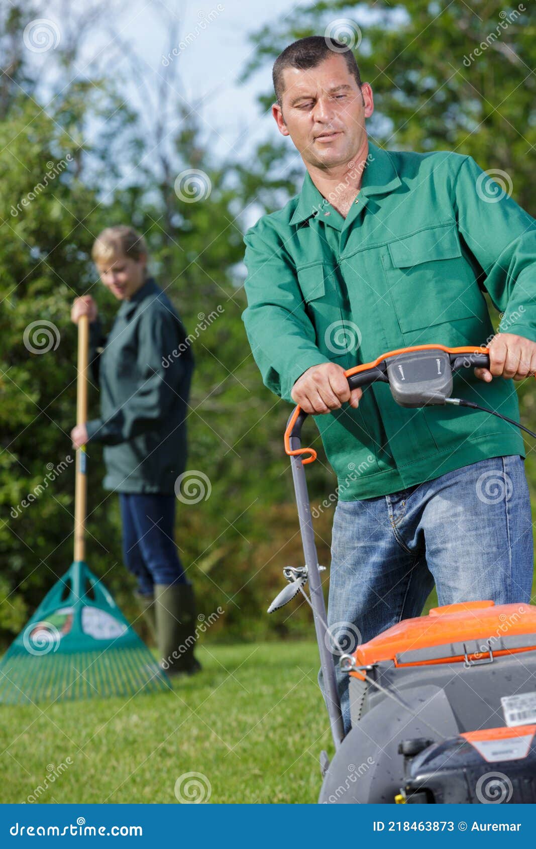 Man mowing grass in garden stock image. Image of mower 218463873