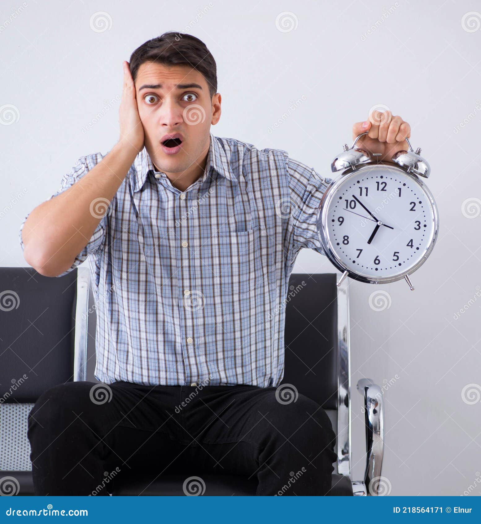 Man Nervously Impatiently Waiting In The Lobby Stock Photo man-nervously-impatiently-waiting-in-the-lobby-stock-photo