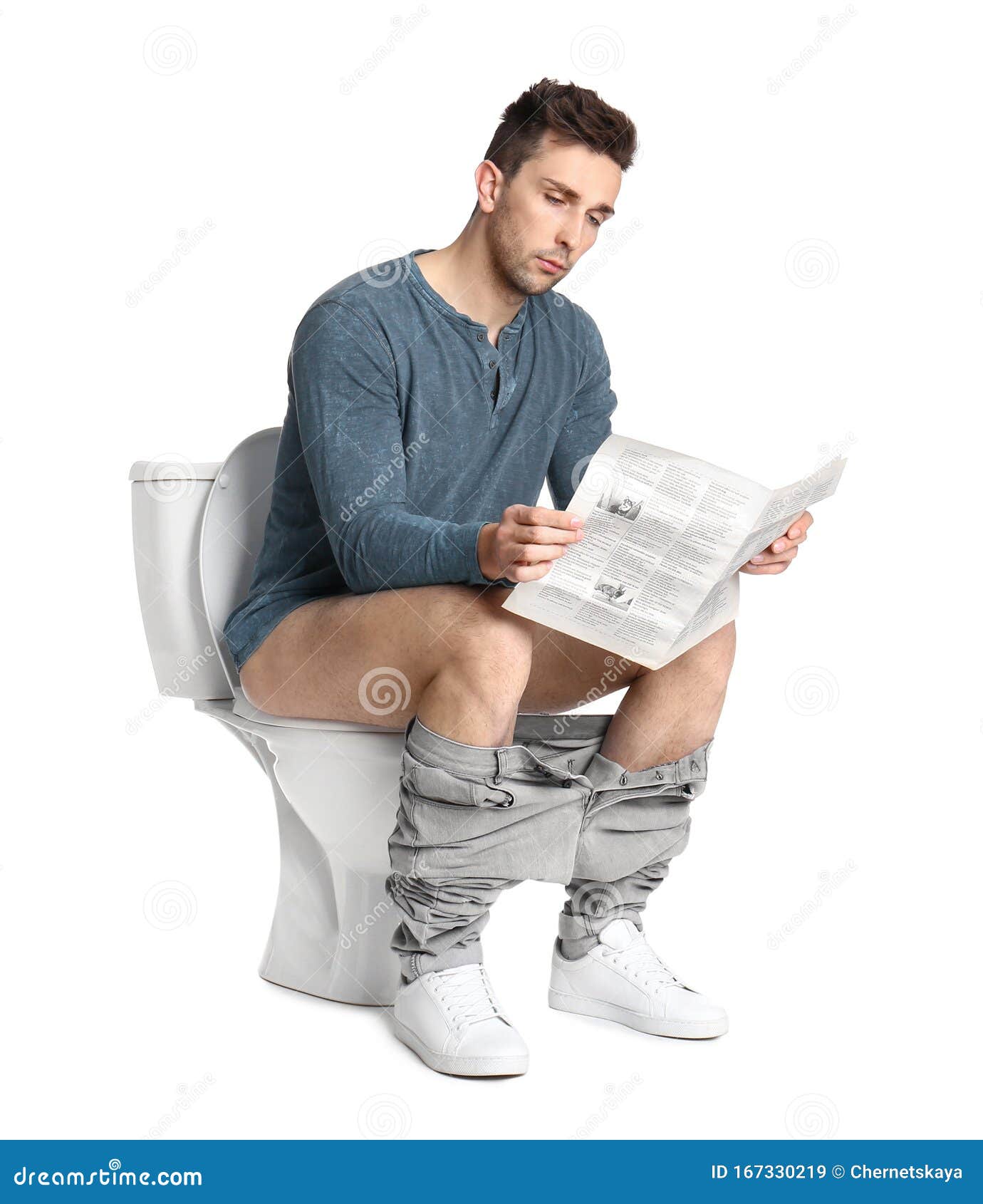 Man Sitting On Toilet Seat Reading A Newspaper Stock Image 