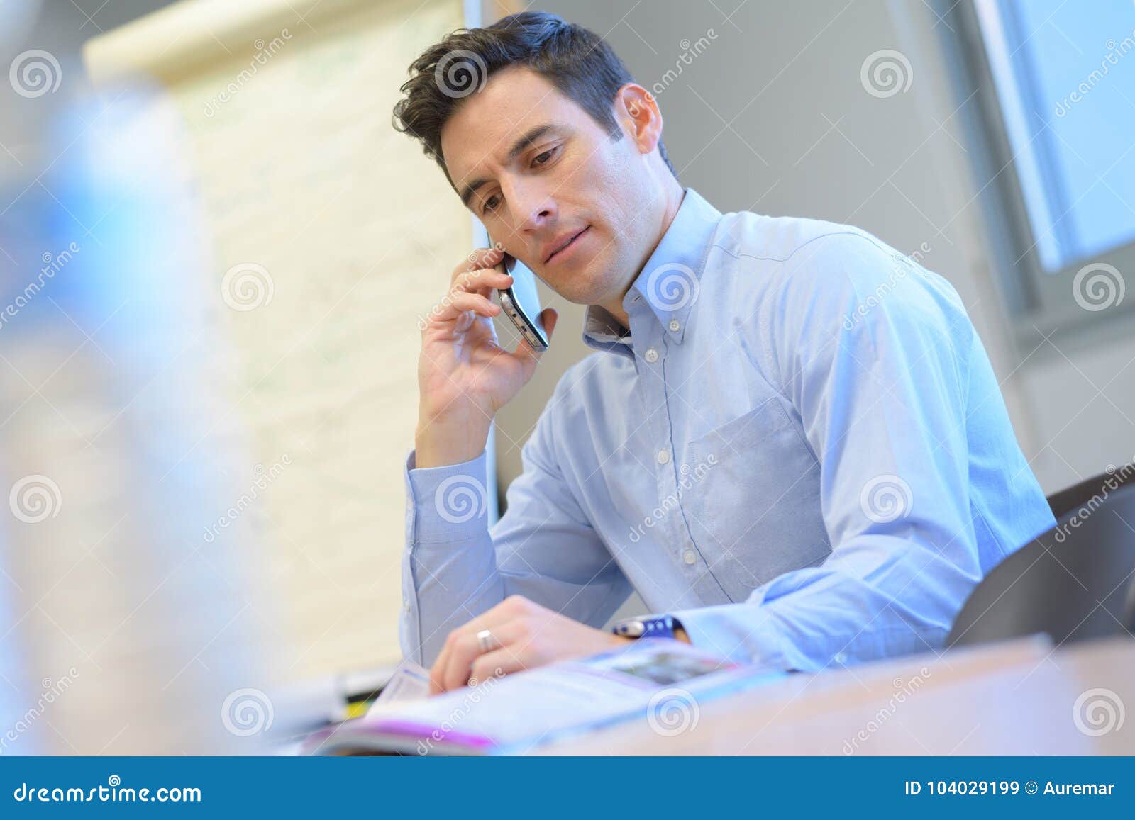 man in office with mobile phone