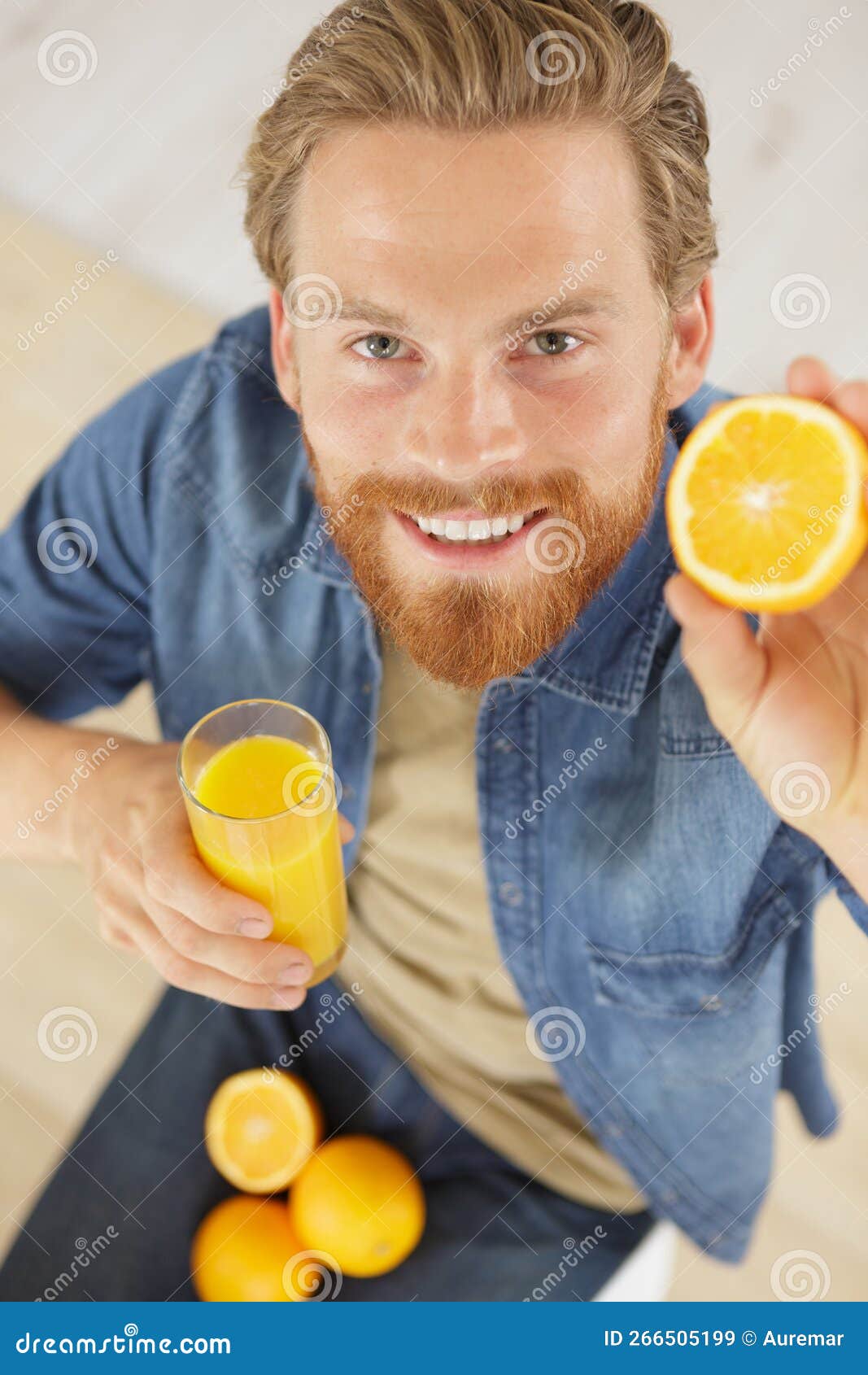 Man with Oranges Drinking Orange Juice at Table Stock Image Image of