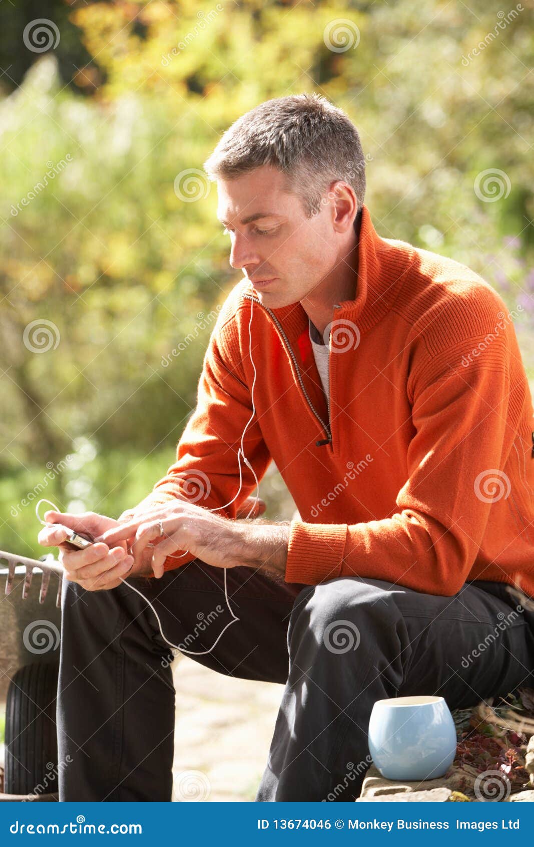 man outdoors listening to mp3 player