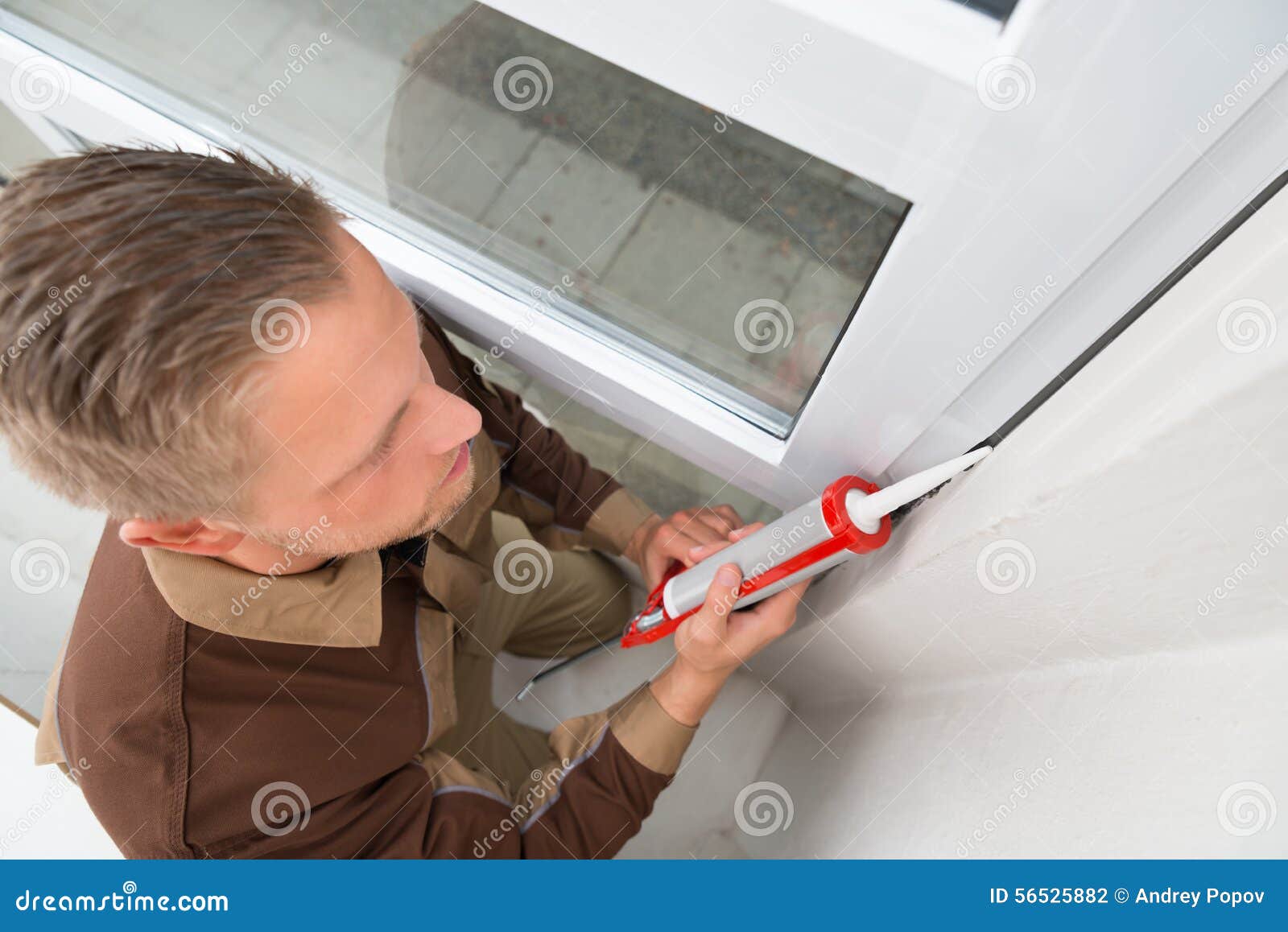 Man in Overall Applying Silicone Sealant Stock Photo Image of