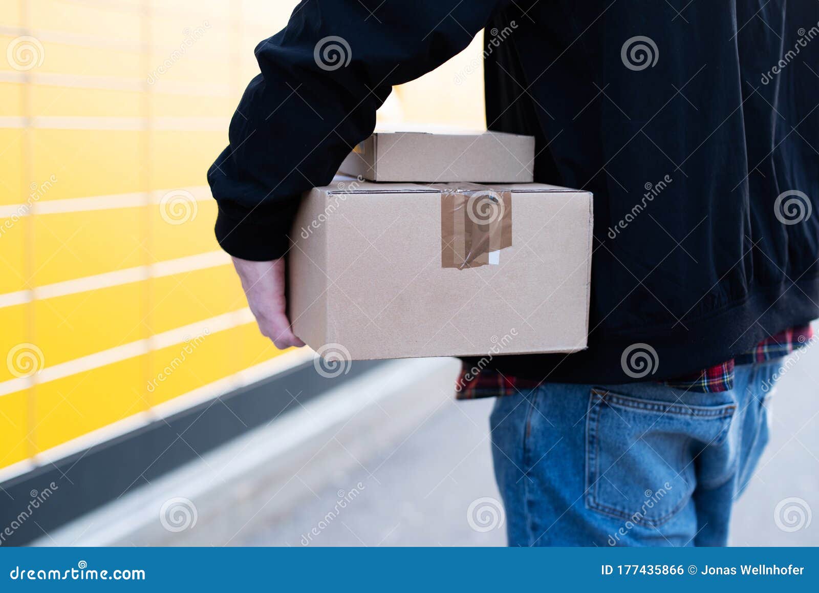 A Man at a Packing Station, Collecting and Sending Parcels Stock Photo