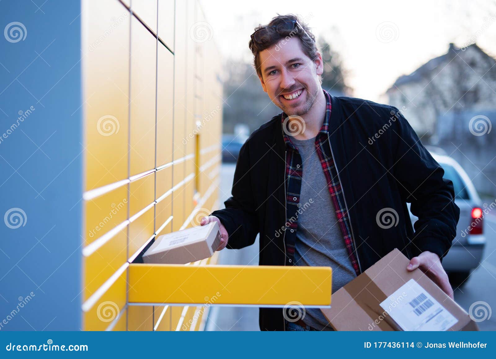 A Man at a Packing Station, Collecting and Sending Parcels Stock Photo