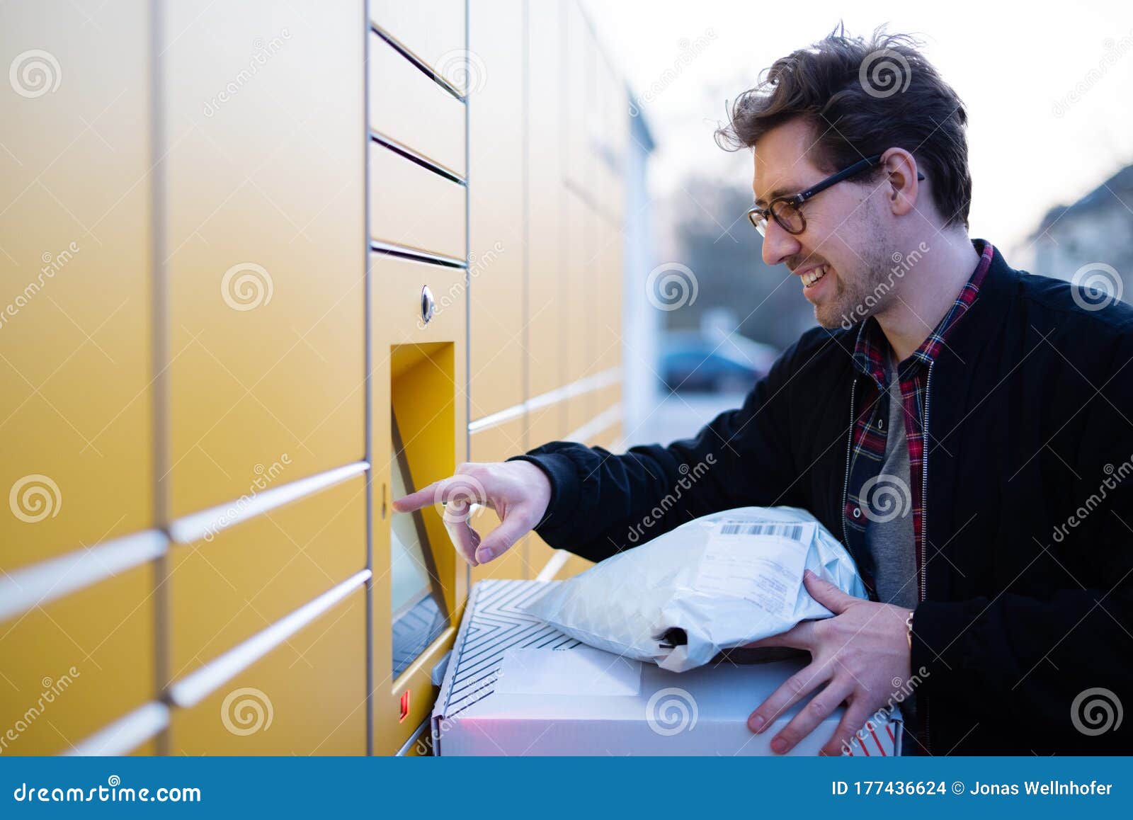 A Man at a Packing Station, Collecting and Sending Parcels Stock Photo