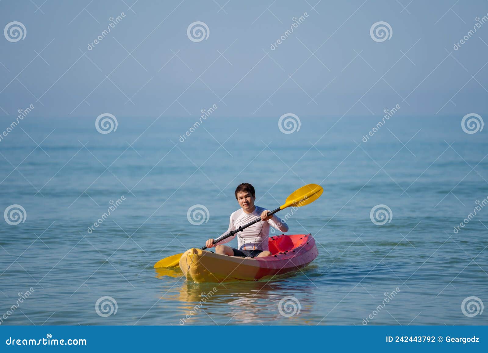 Man Paddling a Kayak Boat in Sea Stock Photo Image of jacket