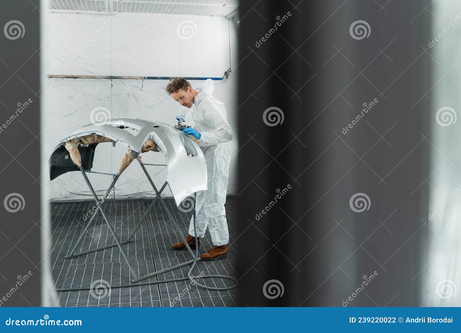 Man Painting Car Bumper in Paint Booth. Stock Photo Image of bodywork