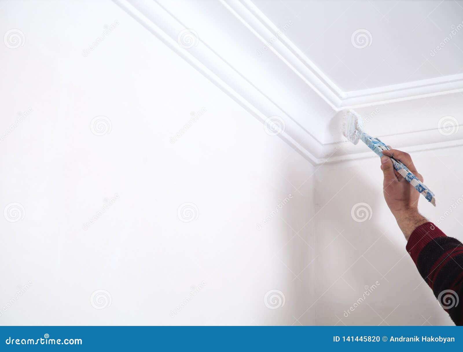 Man Painting Ceiling With White Color Renovation Stock