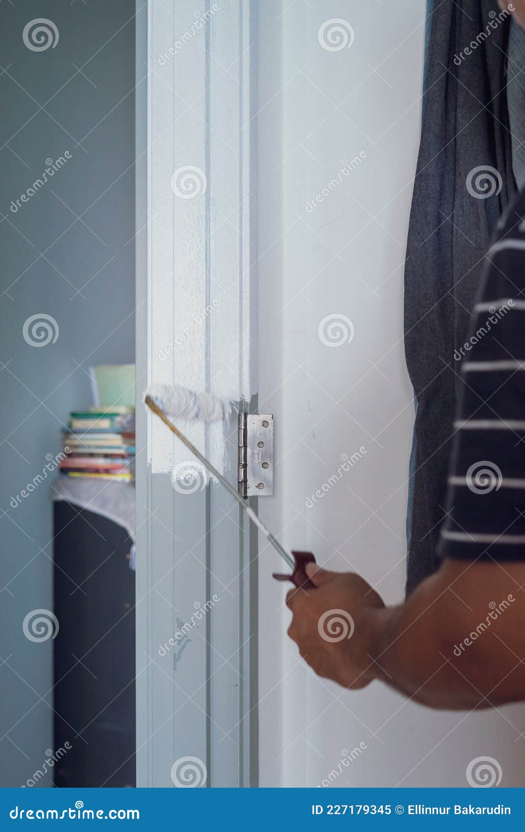 Man Painting Door Frame with Roller. Home Improvement Project Stock