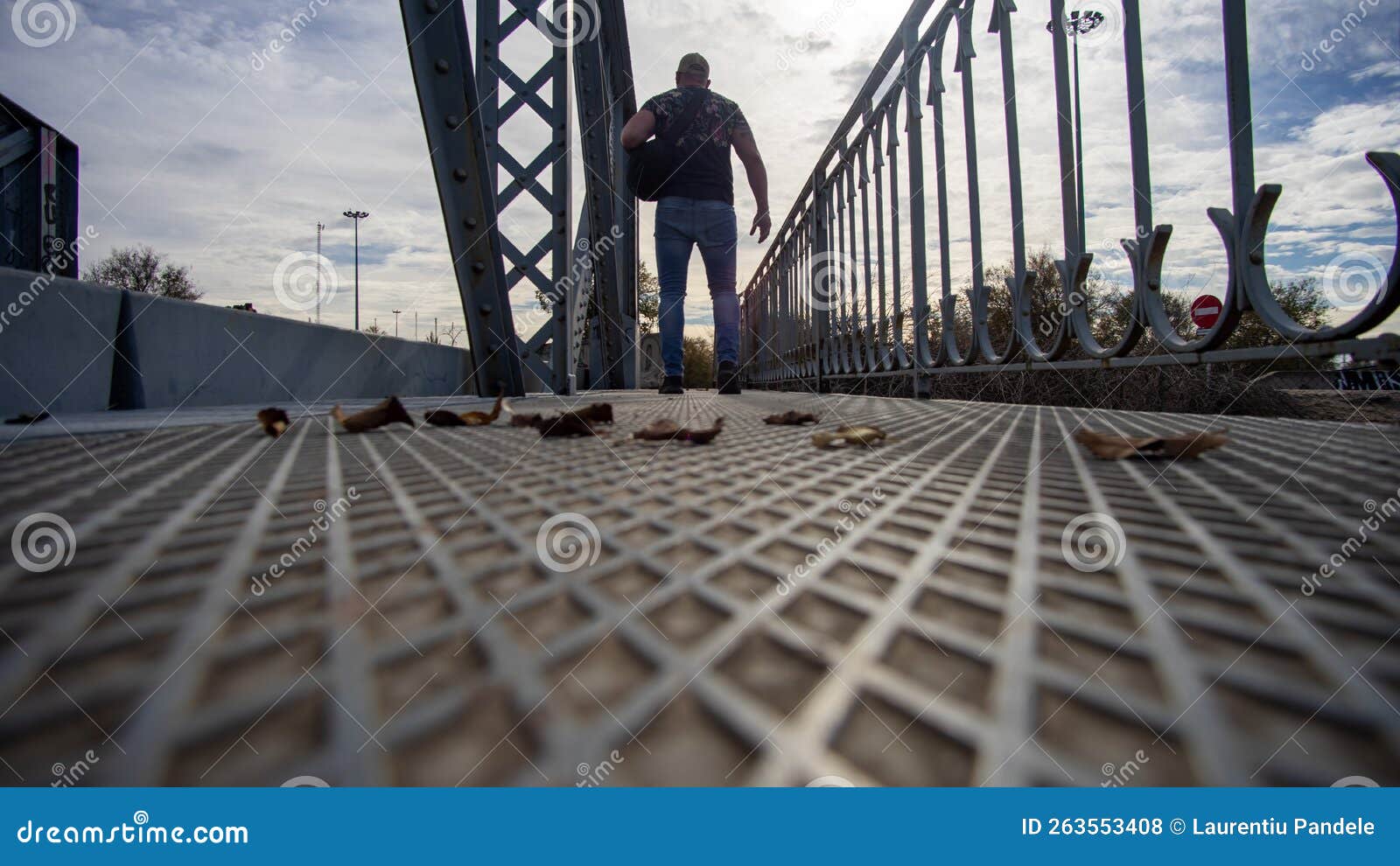 man passing metallic bridge in arganda del rey madrid spain