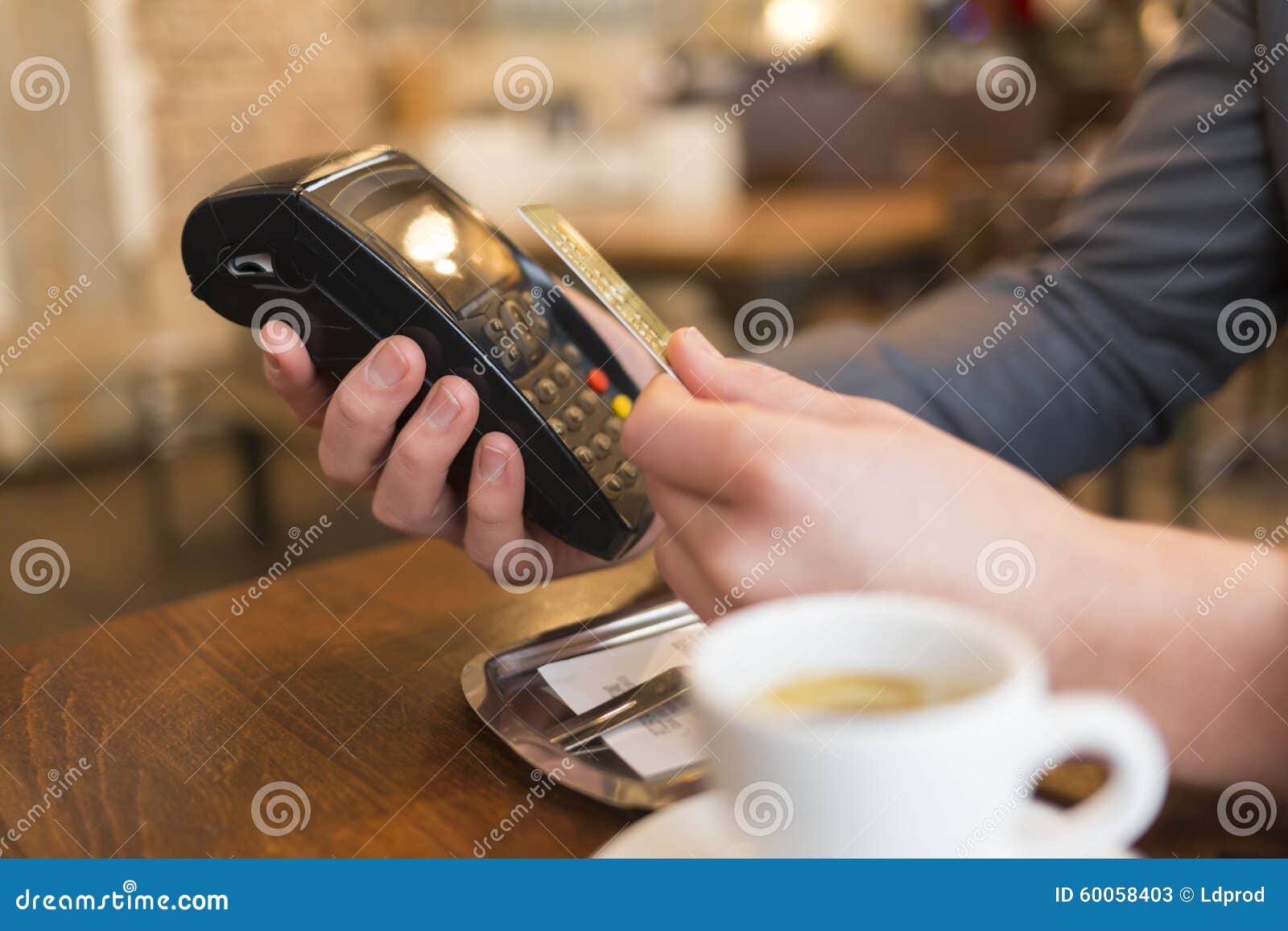 man paying with nfc technology , credit card, in restaurant, bar