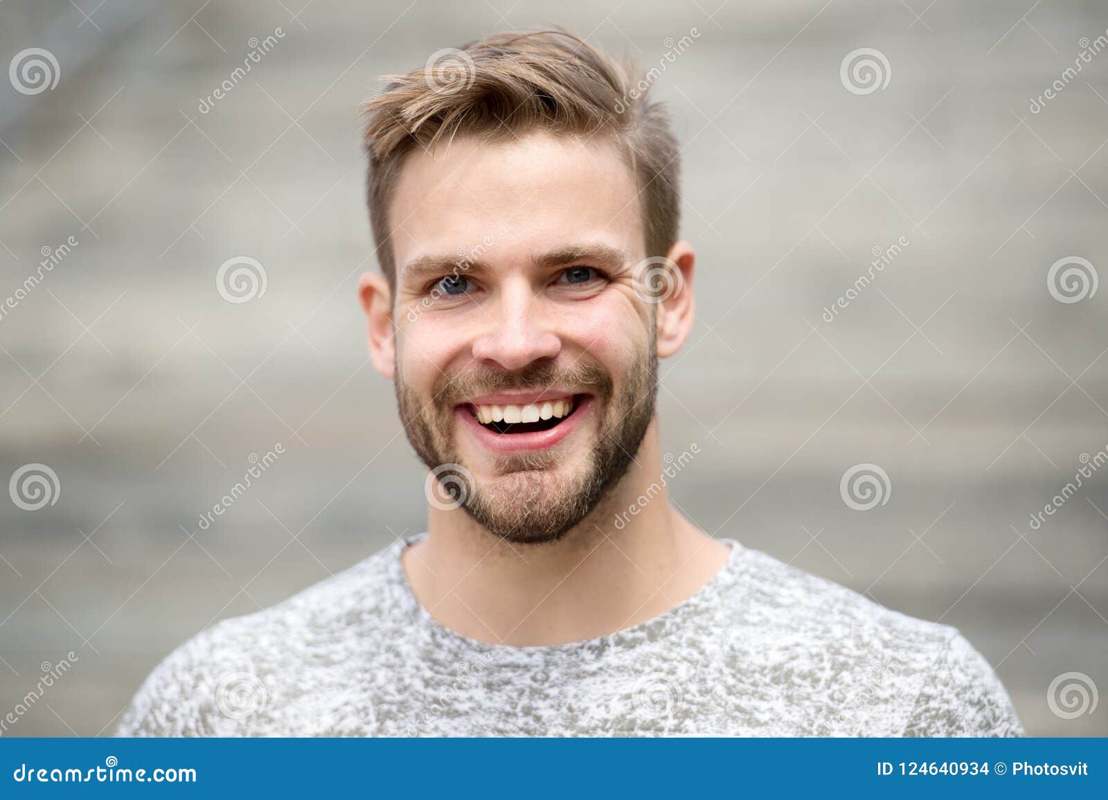 man with perfect brilliant smile unshaven face defocused background. guy happy emotional expression outdoors. bearded