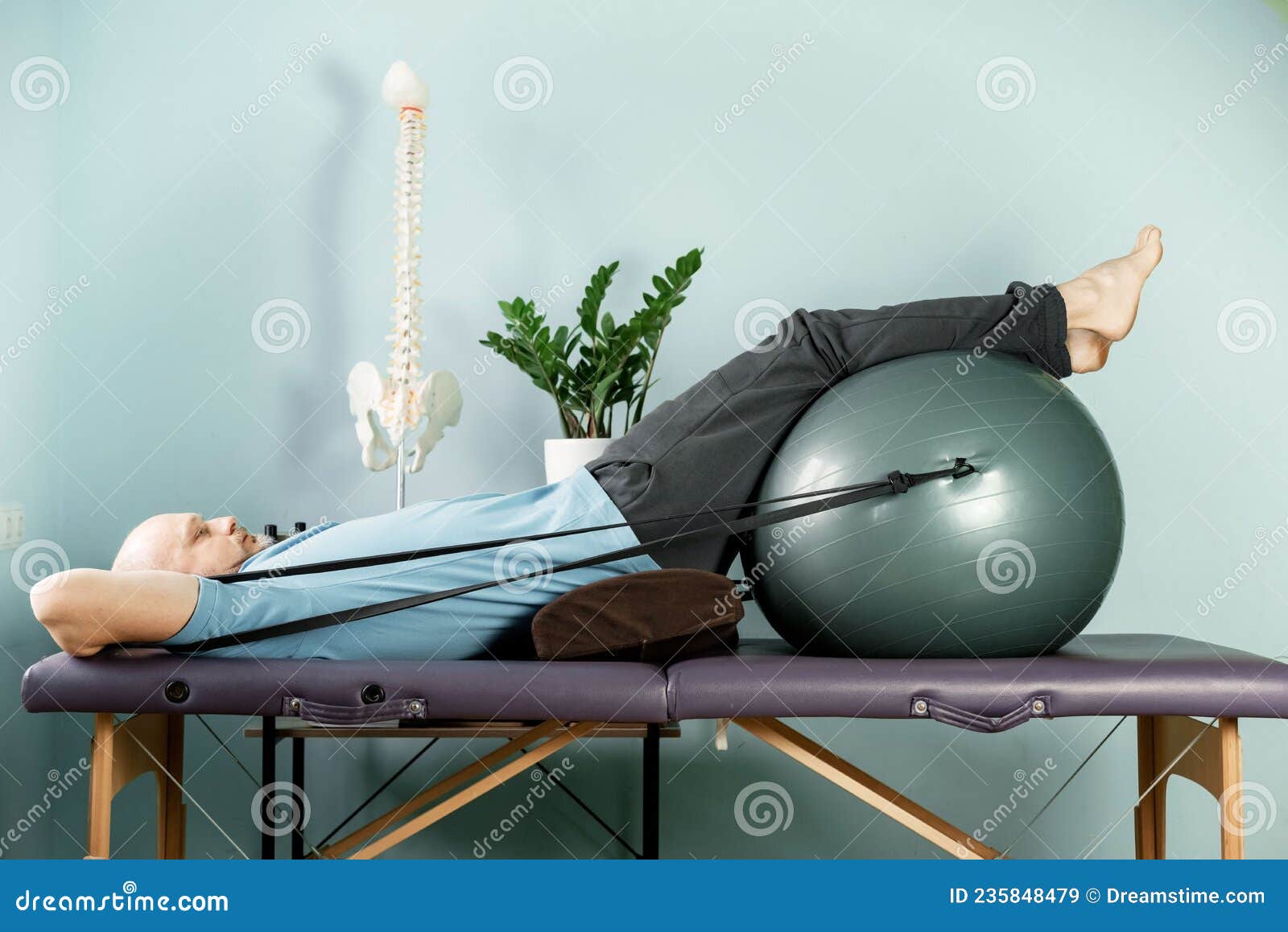 rotation exercises on the fitness ball with resistance bands in constructive rest position