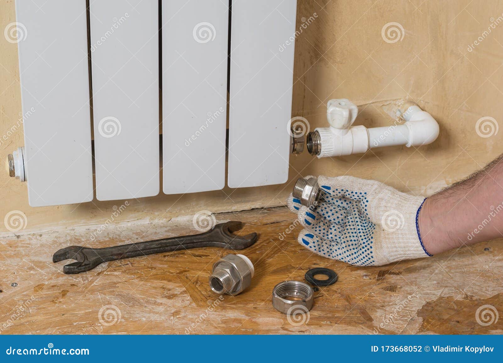 A Man Performs Repairs To the Heating System in a Private Home