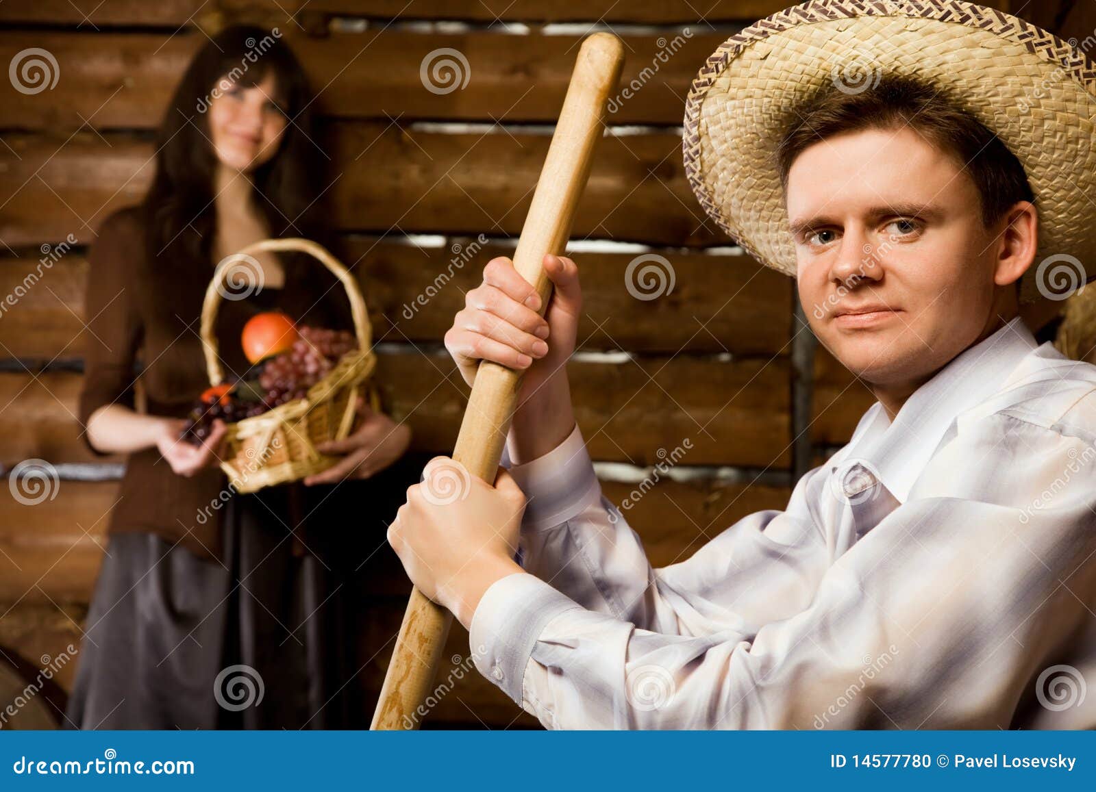 Man with Pitchfork and in Hat, Woman with Basket Stock Photo Image of