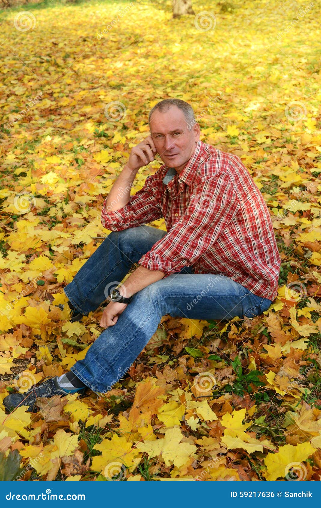 A Man in a Plaid Shirt is Sitting in Autumn Park. Stock Photo - Image ...